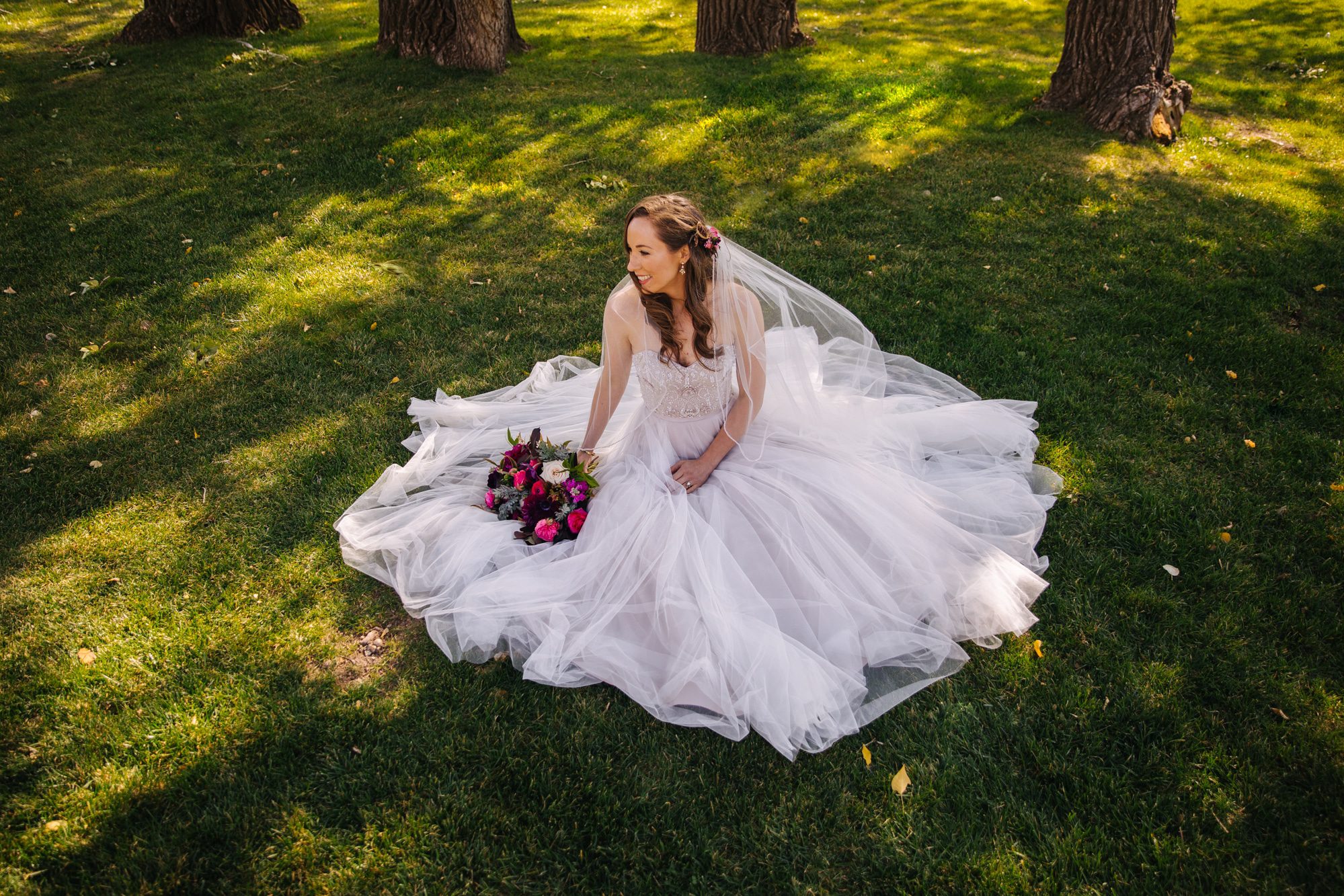 bride with dress fanned out, bride sitting down, fan out wedding dress, outdoor wedding, bridal portrait, fun bridal photo, fun bridal portraits