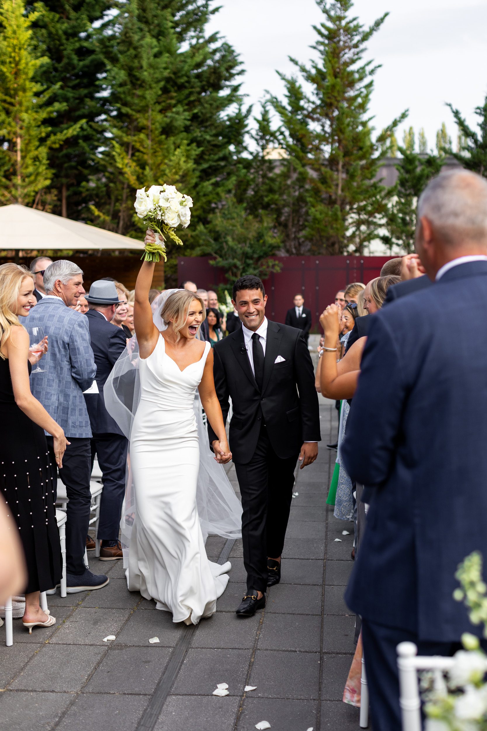 Bride and groom walking back down the aisle during their winery wedding in Woodinville Washington at Novelty Hill Januik winery.