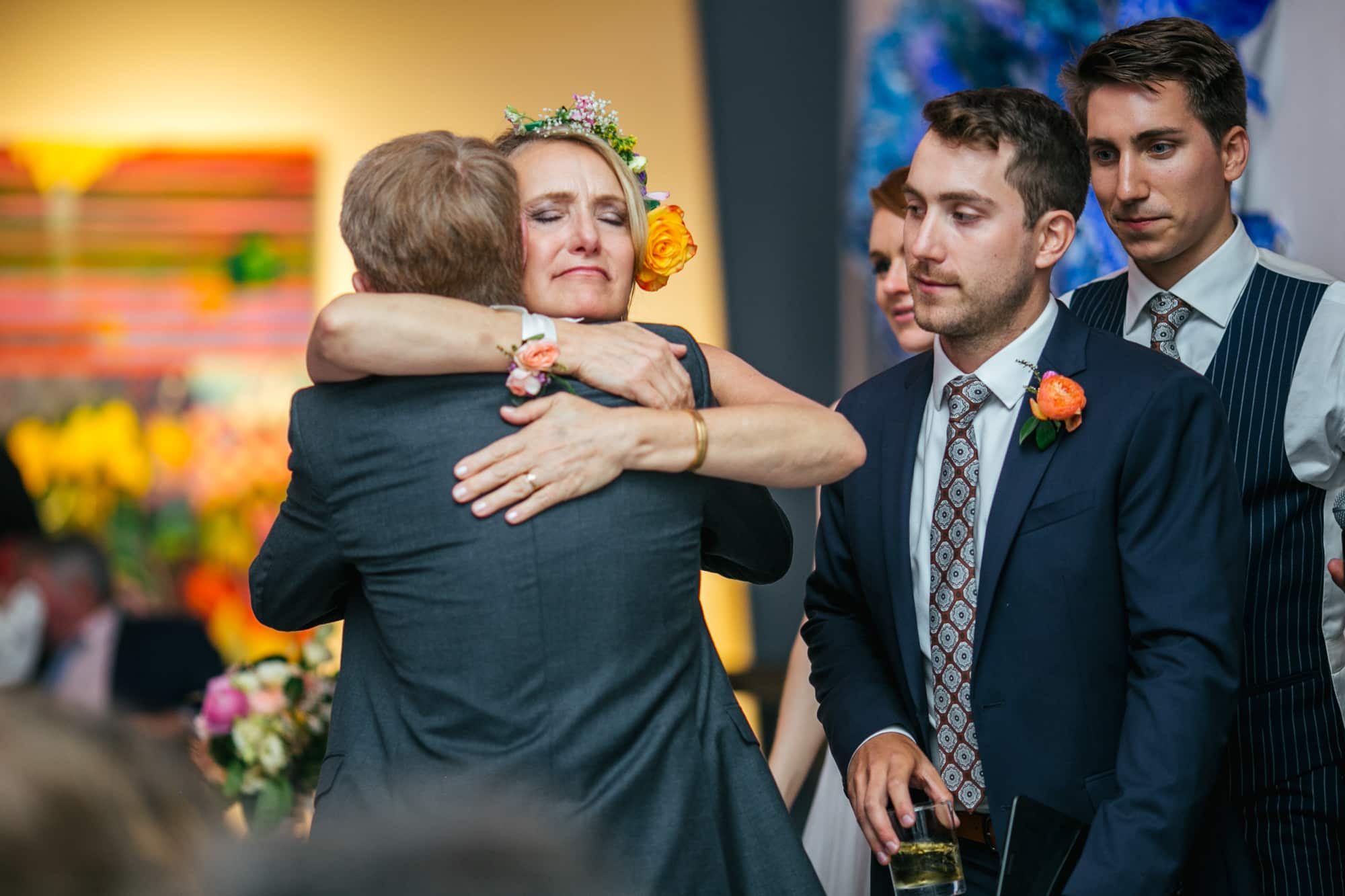 mom and son, mother of the groom, both families hugging, happy family