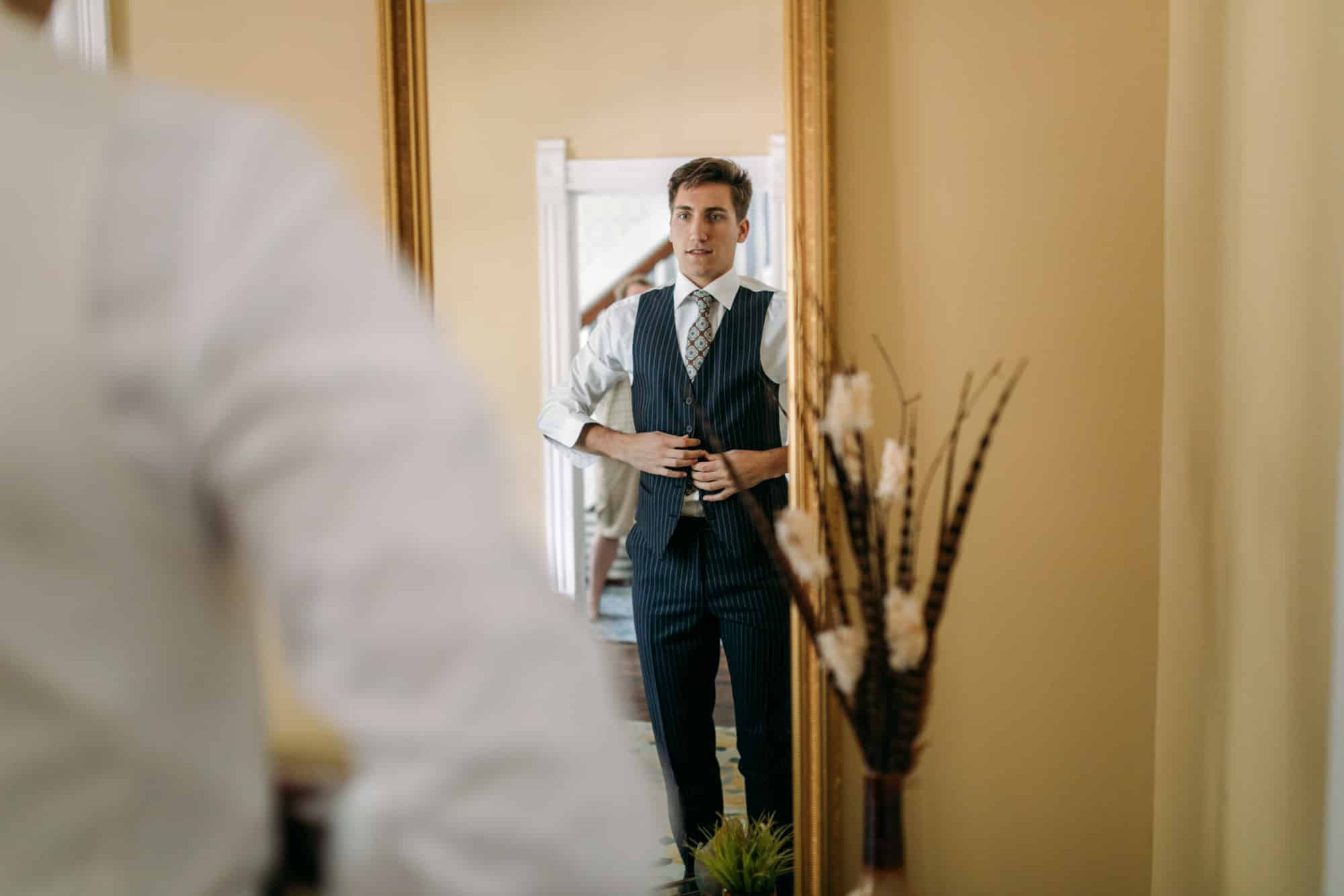 groom getting ready, getting ready at airbnb, groom tie ideas, groom tie, groom getting ready by himself, groom getting ready alone, groom in vest, mens dress shoes