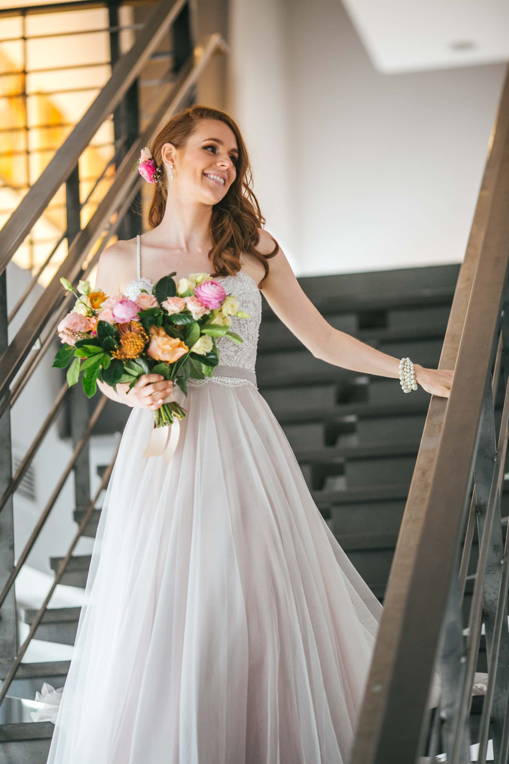 bride coming down stairs, flowy wedding dress, colorful wedding flowers, colorful bouquet, red haired bride, space gallery denver wedding, bride walking down aisle, denver wedding venue, denver wedding photographer, red haired bride