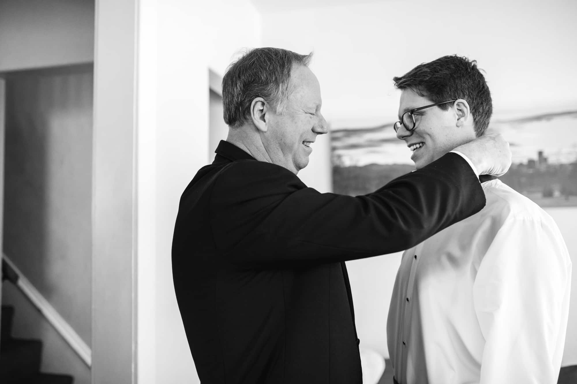 groom with dad, getting ready groom dad, bow tie groom, groom getting ready, groomsmen getting ready, groomsmen in tuxes, tuxedo groomsmen, black tie wedding, pre wedding getting ready, denver wedding, urban wedding