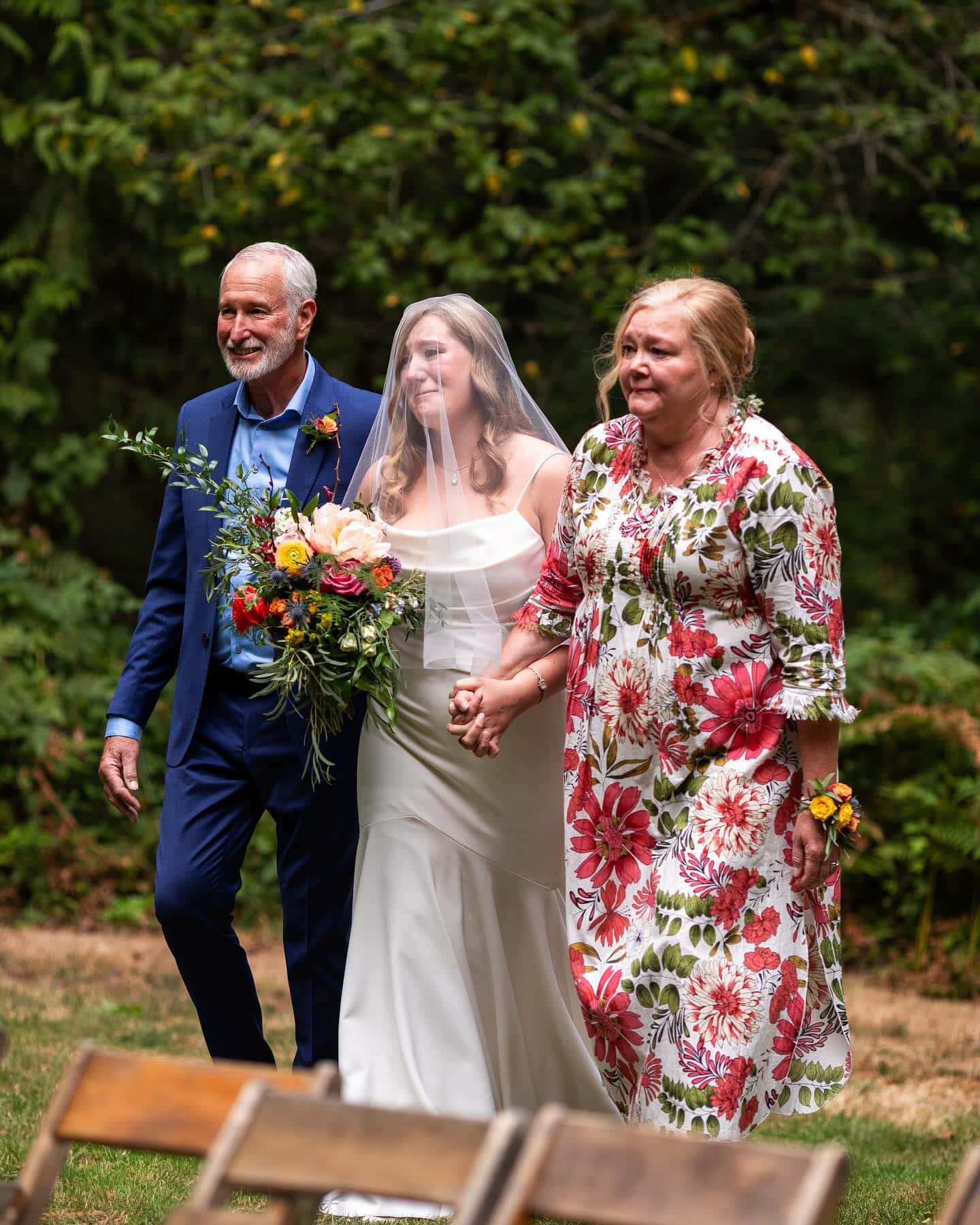 Bride walking with her parents down the aisle at Islandwood during their Seattle Bainbridge Island wedding.