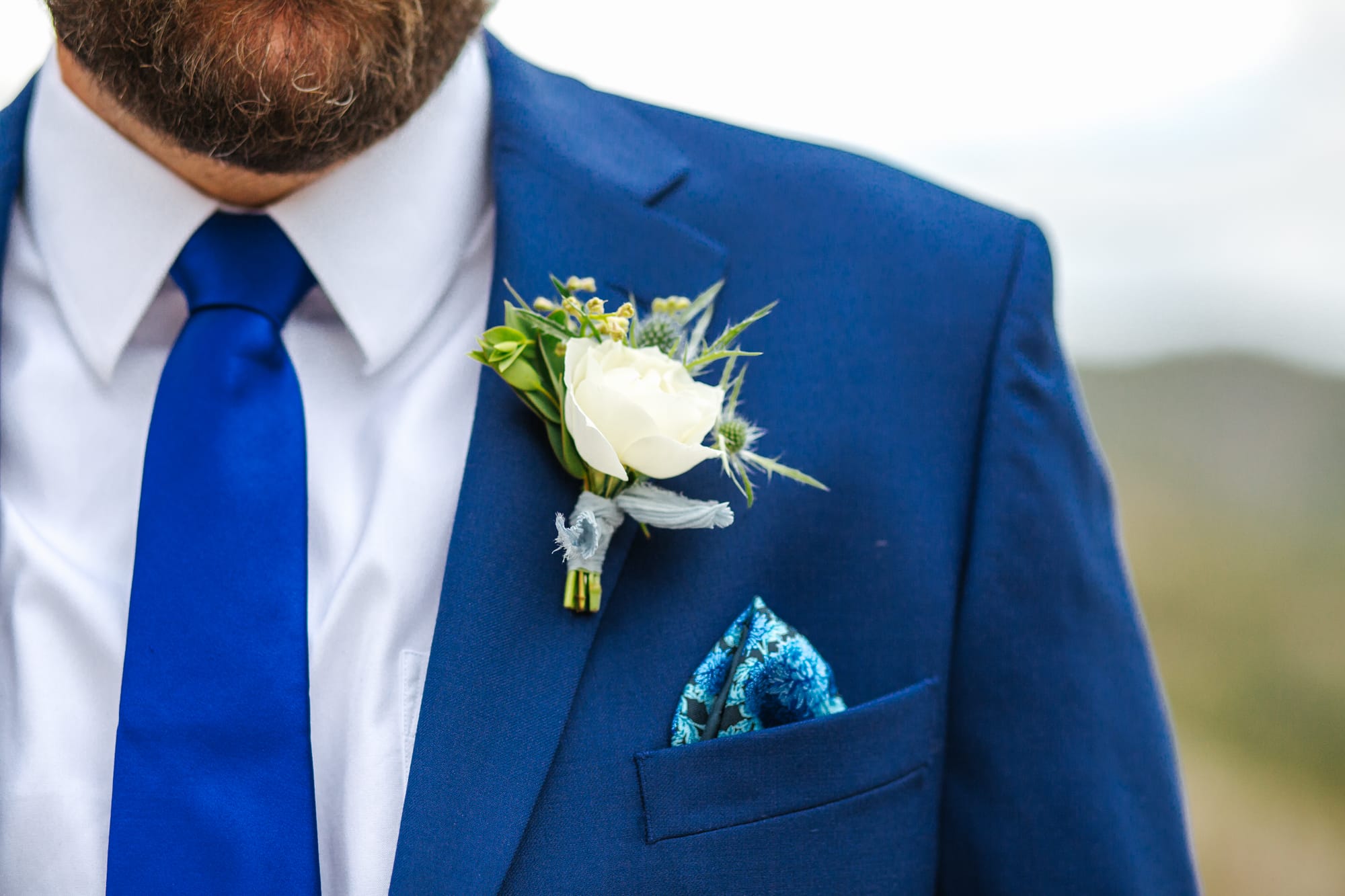 sapphire point, sapphire point wedding, blue suit groom, blue pocket square, colorful wedding photographer, colorful colorado wedding, intimate wedding, intimate wedding photographer, groom details, white groom flowers