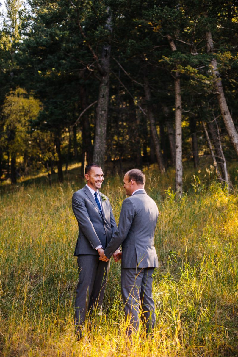 the pines at Genesee, the pines at Genesee venue, lgbt, two grooms, lgbtq, lgbt photographer, denver lgbt photographer, denver photographer, best photographers in denver, lgbt engagement photographer, denver lgbt engagement photographer, lgbt vendors, denver gay marriage, first look, Colorado wedding photographer, LGBT wedding photographer in Denver, LGBT wedding photographer in Colorado, matching boutonnieres, couples portraits in field, posing same sex couples