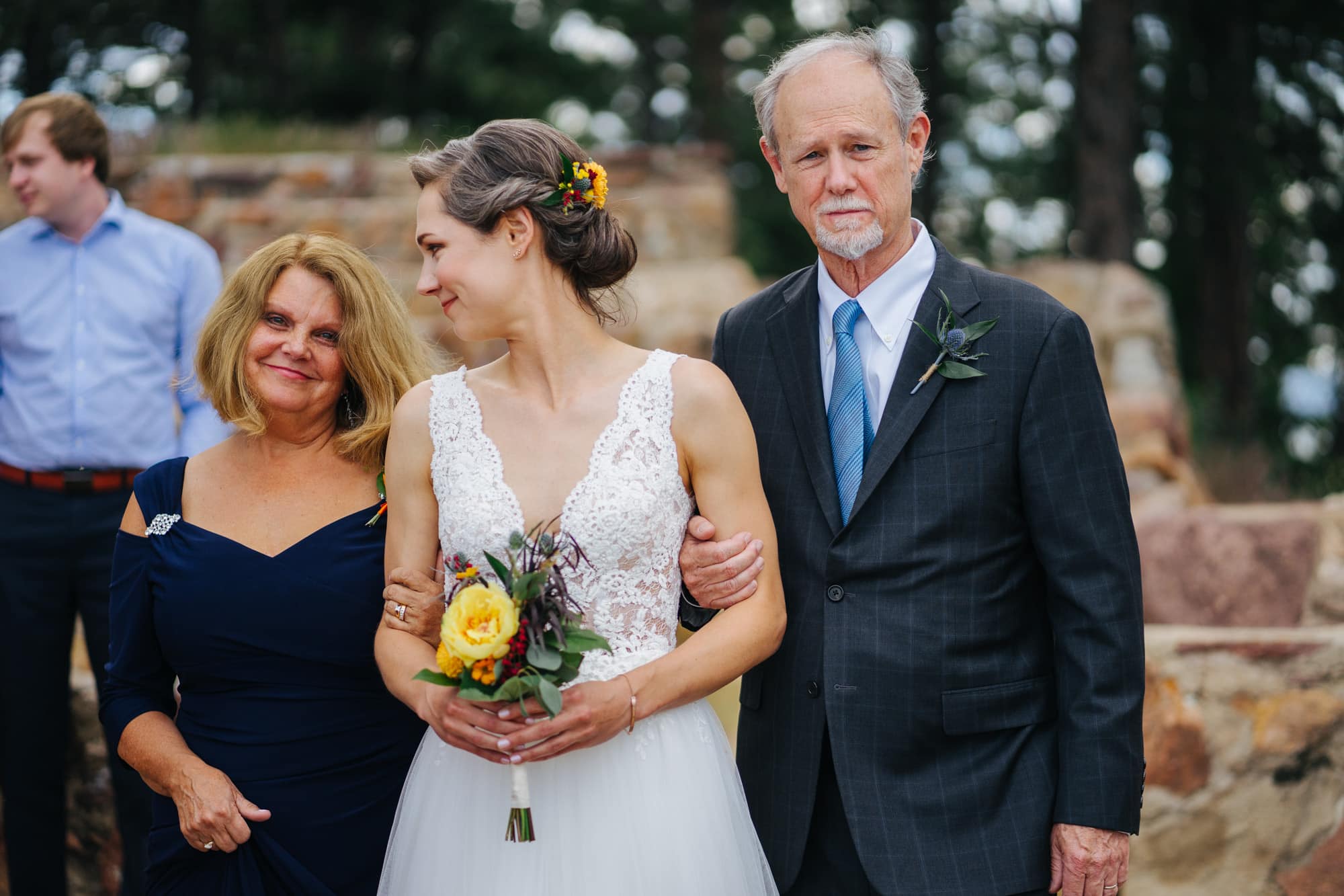 bride with parents, bride and mom and dad, bride with dad, walking down aisle, minimal wedding flowers, yellow wedding flowers