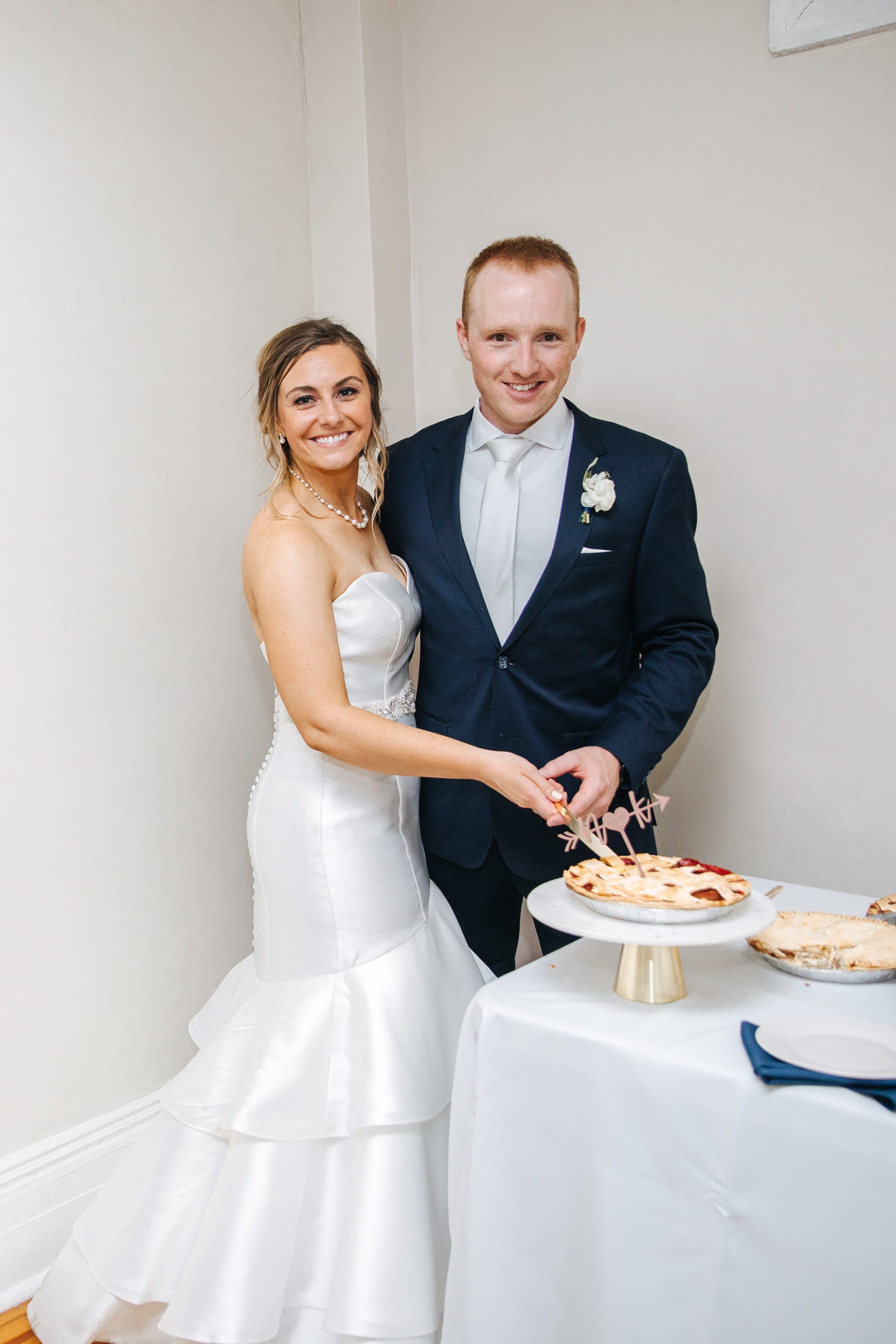 bride and groom cutting pie, pie instead of wedding cake, bride and groom love pie, wedding cherry pie