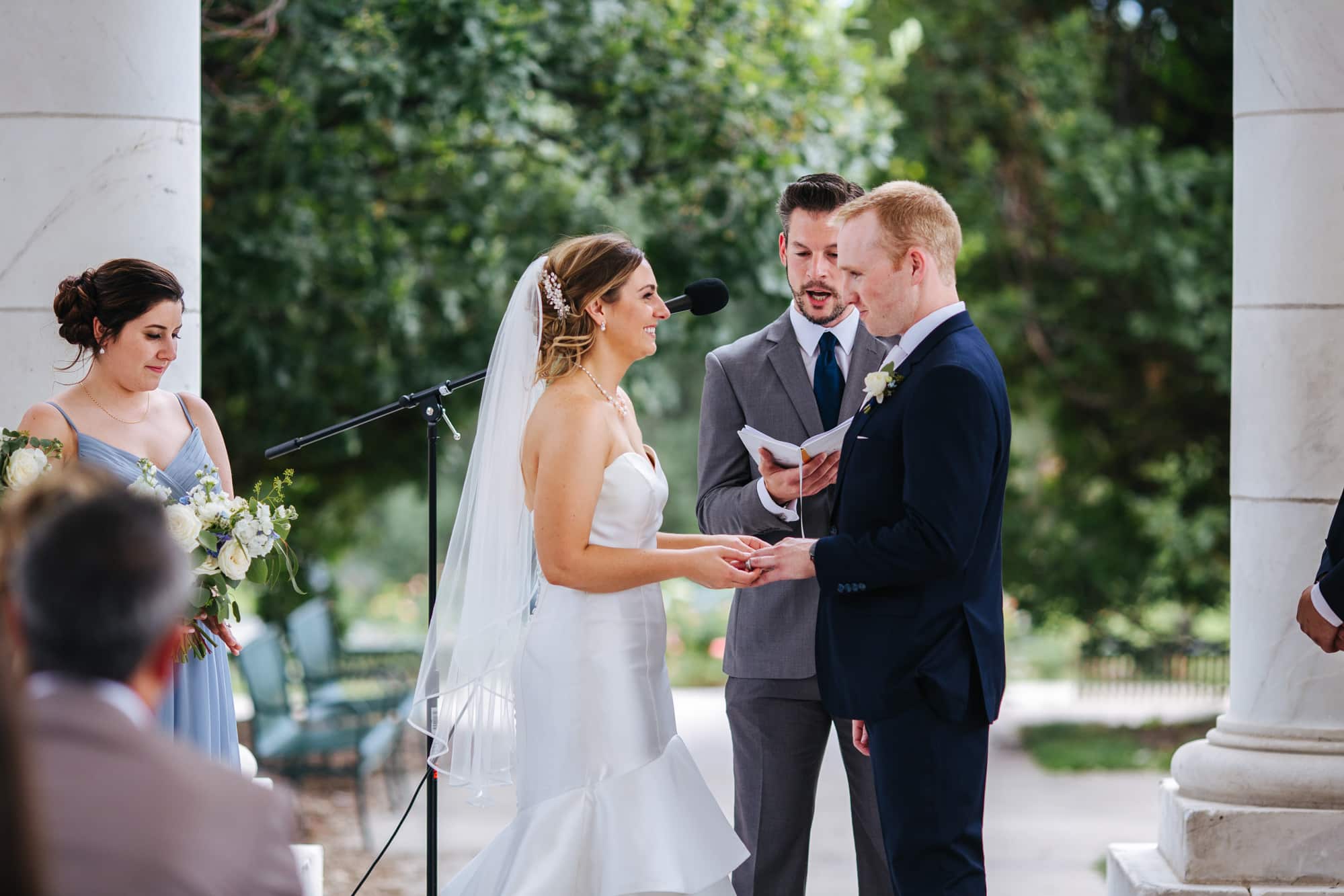 Cheeseman Park wedding, Cheeseman Park, Cheeseman Park denver, denver wedding venues, denver outdoor ceremony, bride and groom exchanging rings, best wedding photographers in denver