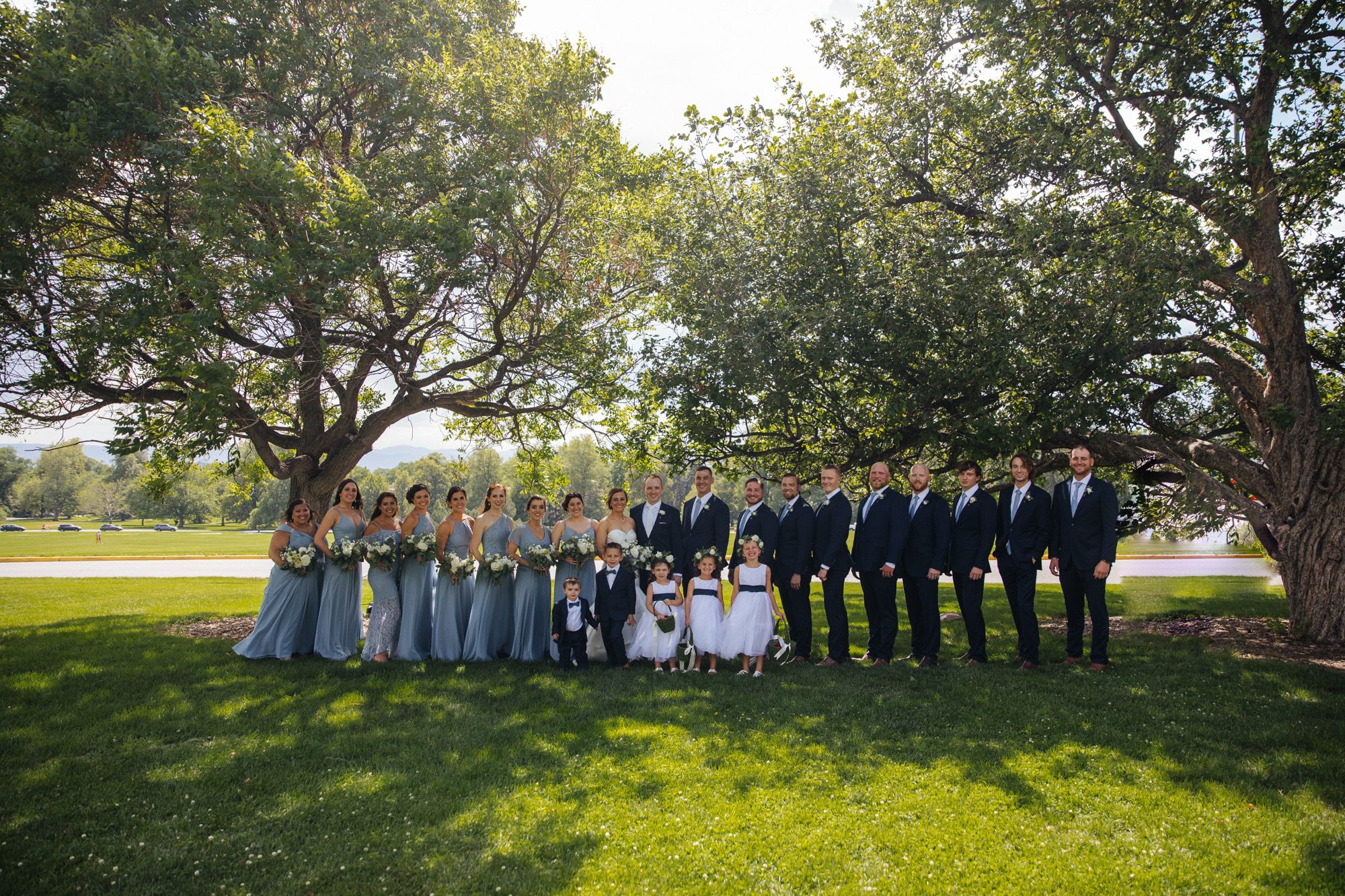 wedding party, wedding party photos, groomsmen and bridesmaids, bride and groom with wedding party, formal wedding photos, outdoor wedding photos, Cheeseman Park wedding, Cheeseman Park denver, light blue bridesmaid dresses, blue suits groomsmen, denver wedding photographer, best wedding photographers in denver