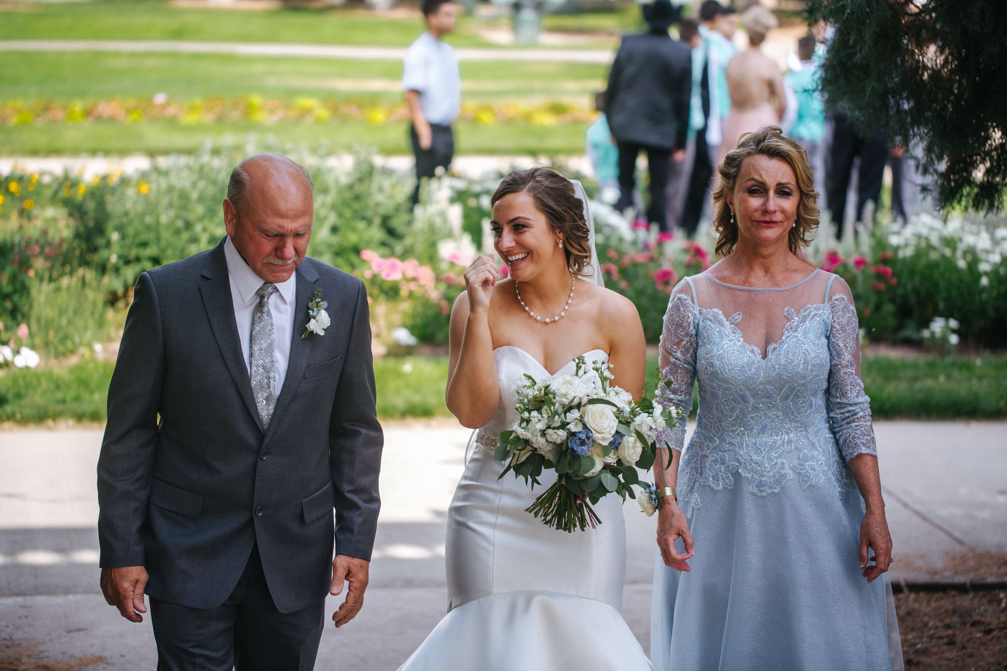 bride with parents, bride with dad before walking down aisle, dad crying with bride, mom crying with bride, bride with parents on wedding day, Cheeseman Park wedding, outdoor wedding ceremony, white wedding flowers, light blue mother of bride dress