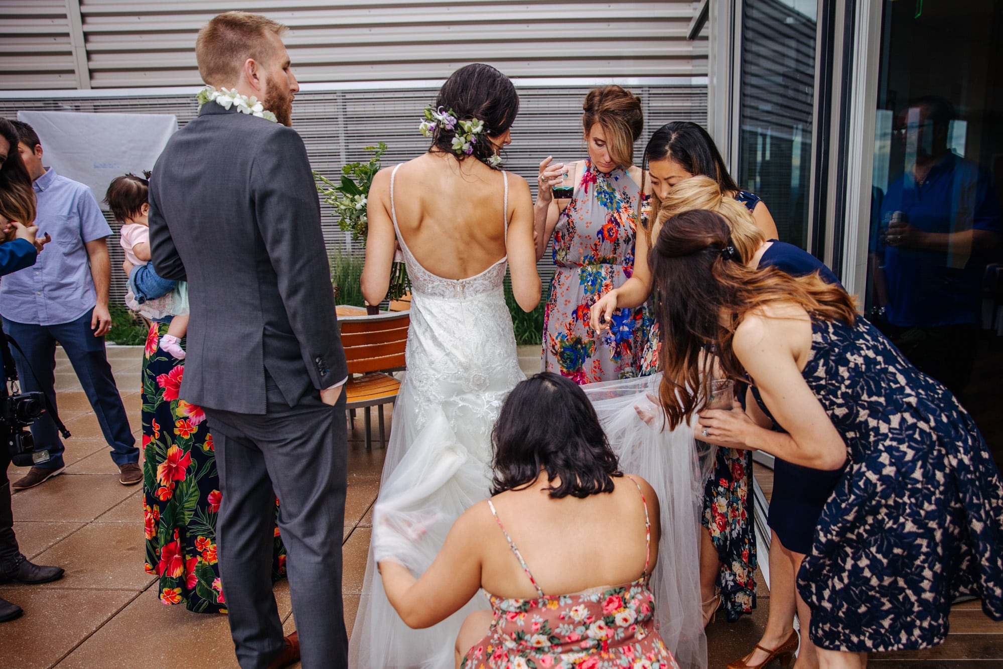 bustling wedding dress, bridesmaids bustling brides dress, putting brides dress up for dancing, bride with bridesmaids
