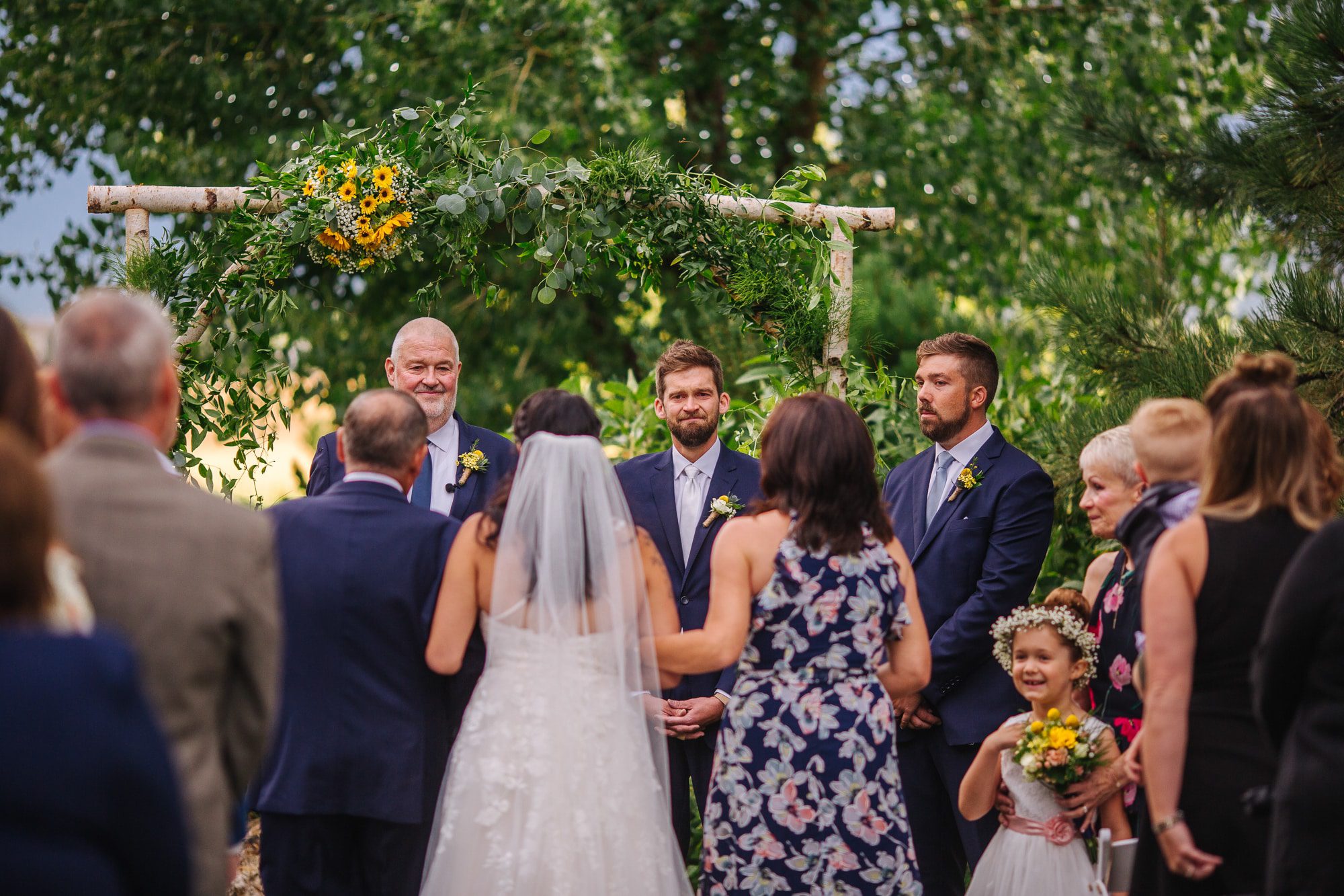 outdoor wedding, wedding ceremony, summer wedding, colorado wedding photographer, colorado wedding ceremony, garden wedding, bride with parents, walking down aisle, bride walking down aisle with mom and dad, grooms reaction, groom crying