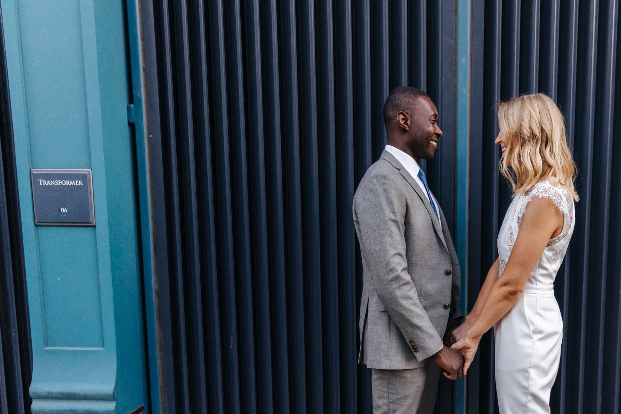 holding hands, formal outfit for elopement, outfit inspiration, bridal pantsuit, bridal jumpsuit, bride in pants, intimate wedding outfit, modern wedding outfits, courthouse wedding outfit, urban wedding photos, modern wedding photos, city wedding, colorado wedding photographer, colorado elopement, colorado wedding photographer