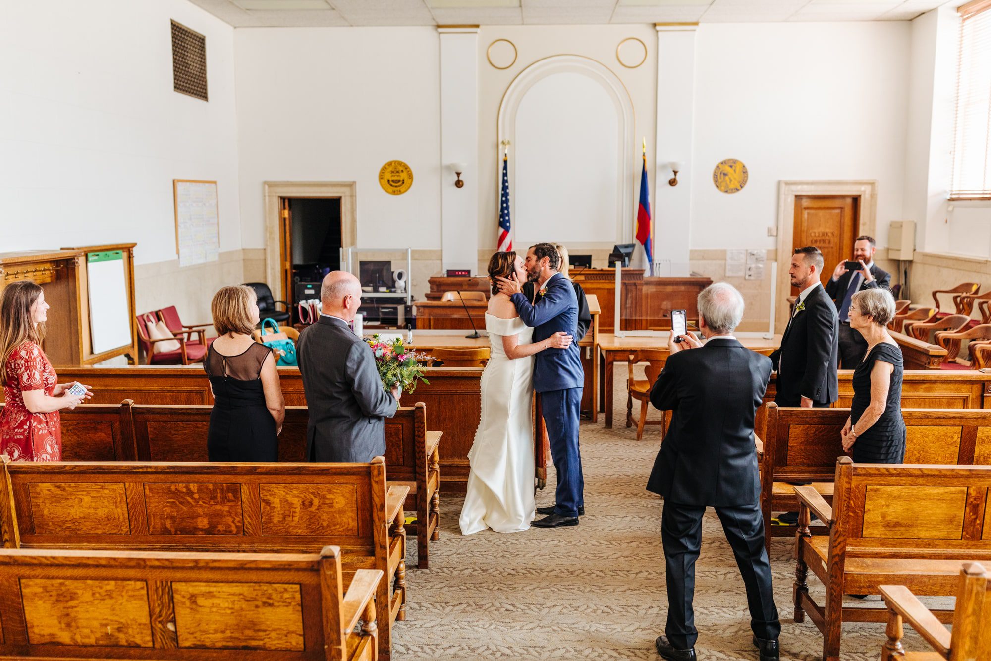 Denver courthouse wedding, civil wedding, small wedding, covid wedding, pandemic wedding, intimate wedding, denver wedding photographer, denver civil union wedding, denver courthouse elopement, Downtown Denver elopement, city and county building denver, denver courthouse, first kiss, wedding kiss, Pregnant bride, off the shoulder wedding dress, simple wedding dresses, elegant wedding dress