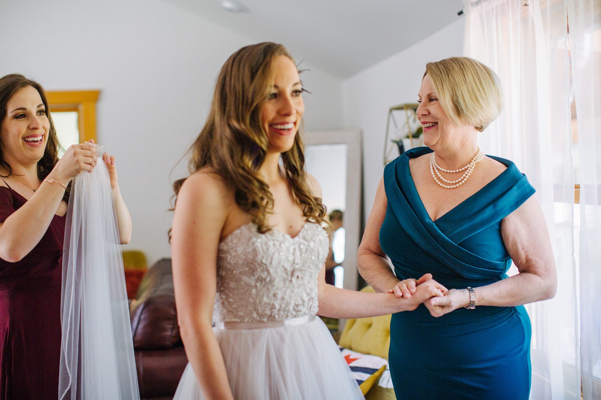 bride with mom, strapless wedding dress, mother of bride dress, dress ideas for mother of bride, getting ready bride, bride getting ready with mom and sister