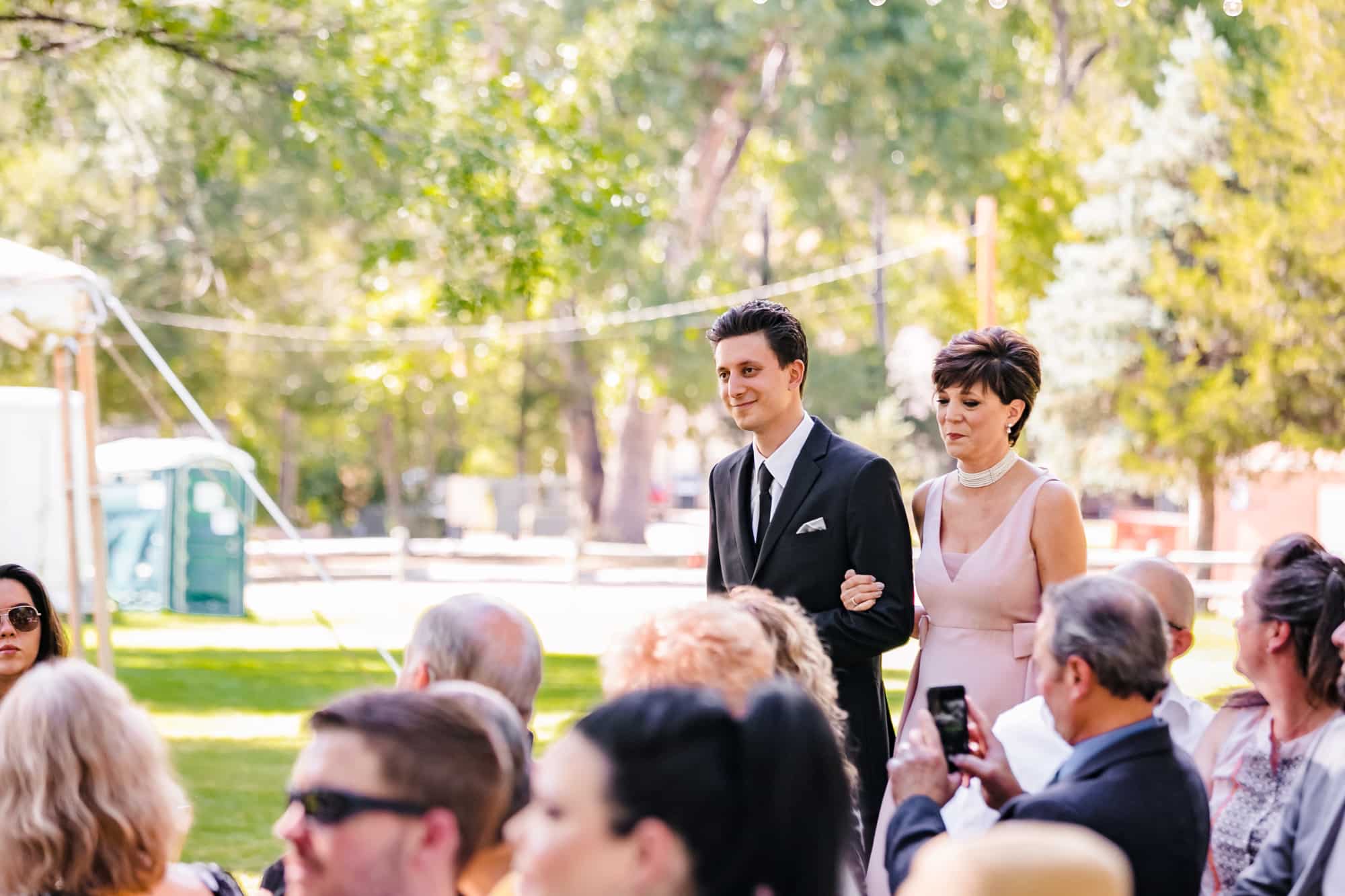 groom and mom, groom walking down aisle, mother of groom dress, outdoor wedding