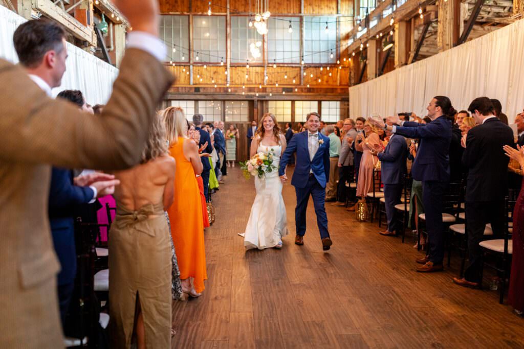 Bride and groom exiting their wedding ceremony at SoDo Park in downtown Seattle.