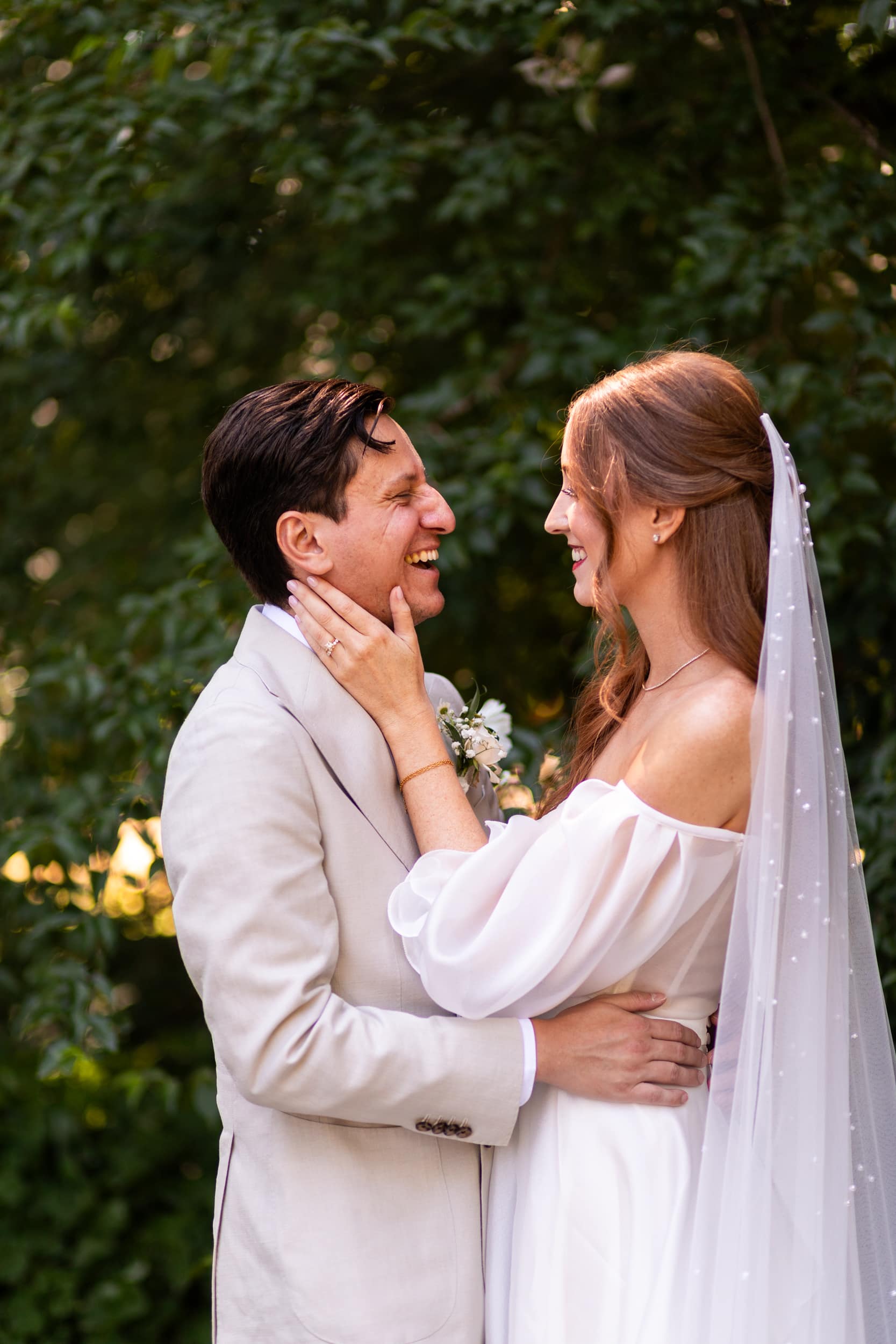 Bride and groom laughing during portraits at Volunteer Park in downtown Seattle before their intimate ceremony.