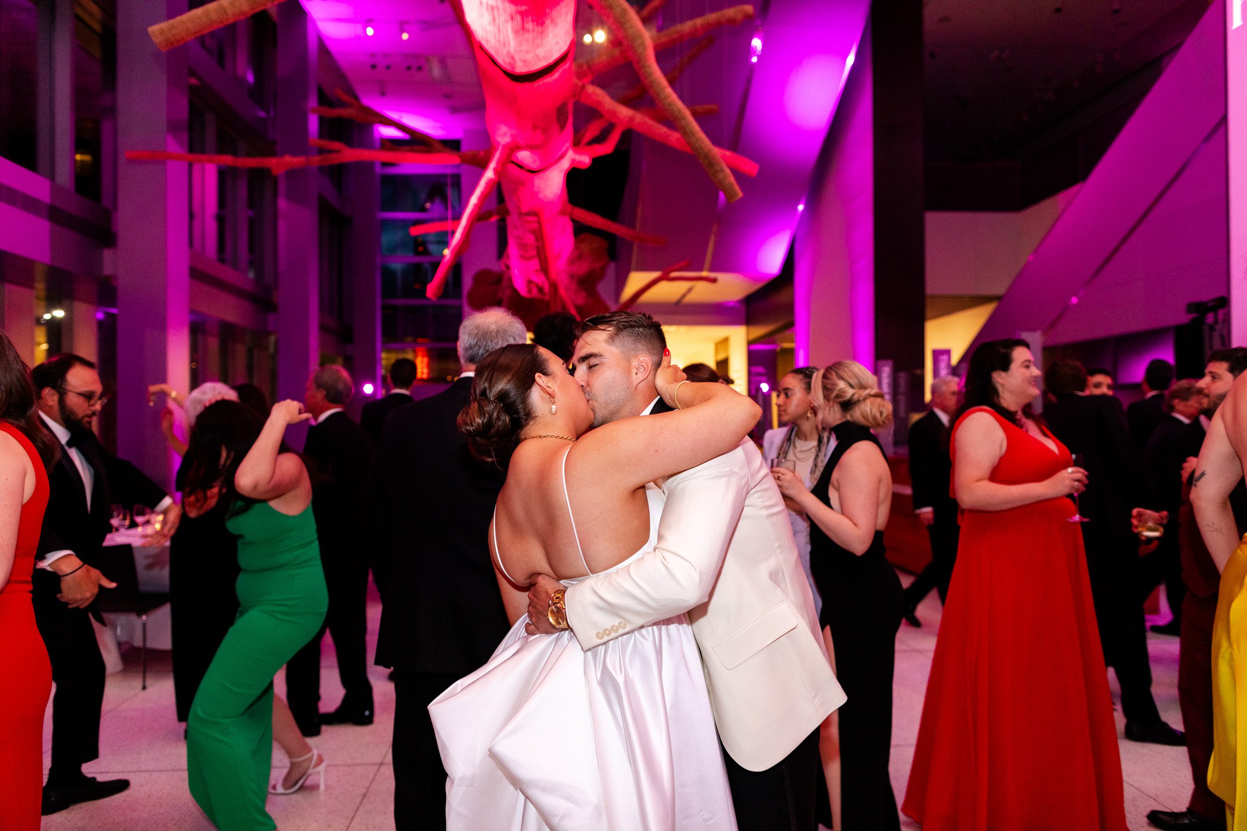 Bride and groom, sharing their first dance underneath the tree sculpture at the Seattle Art Museum during their downtown Seattle wedding