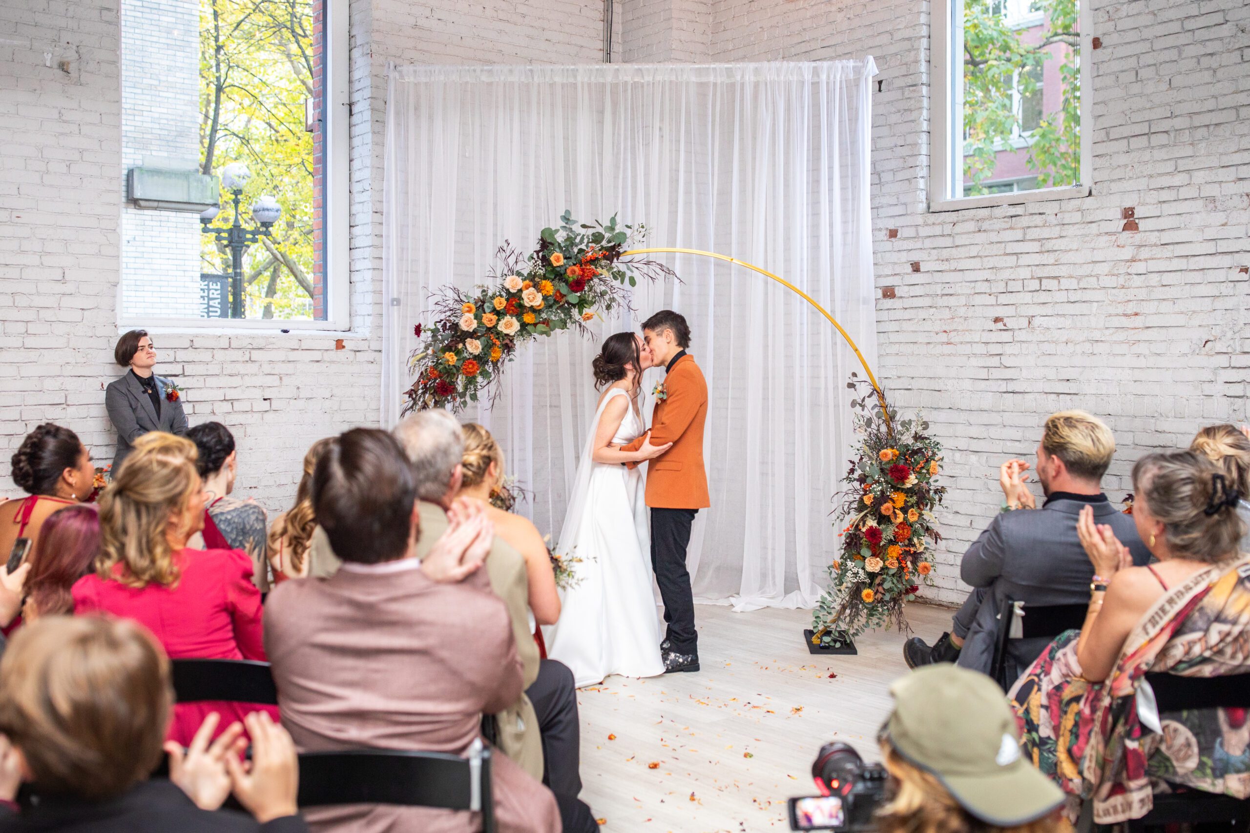 LGBTQ wedding at the 101, brides kissing during their wedding ceremony.
