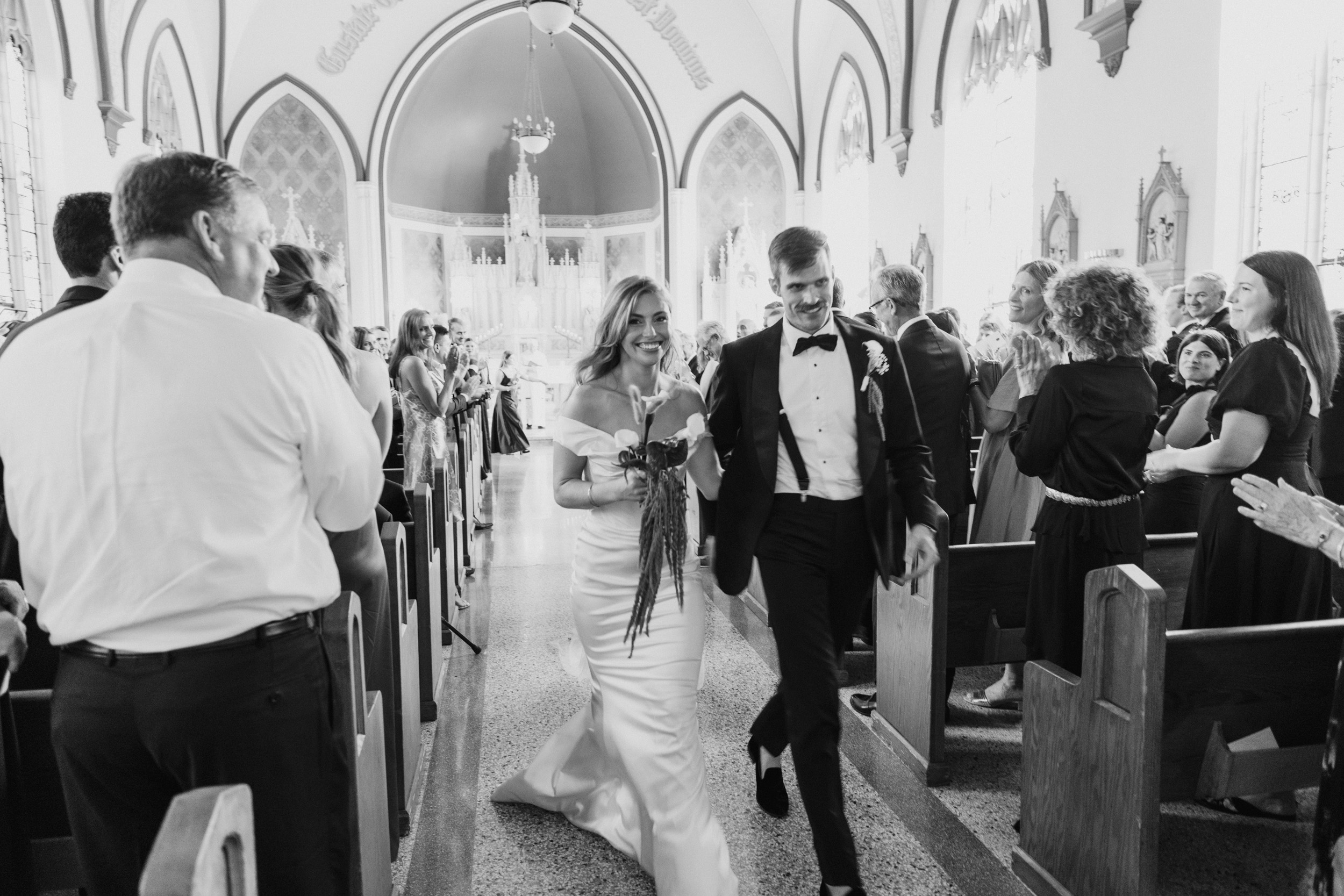 Bride and groom walking back down aisle during Catholic church wedding in Seattle