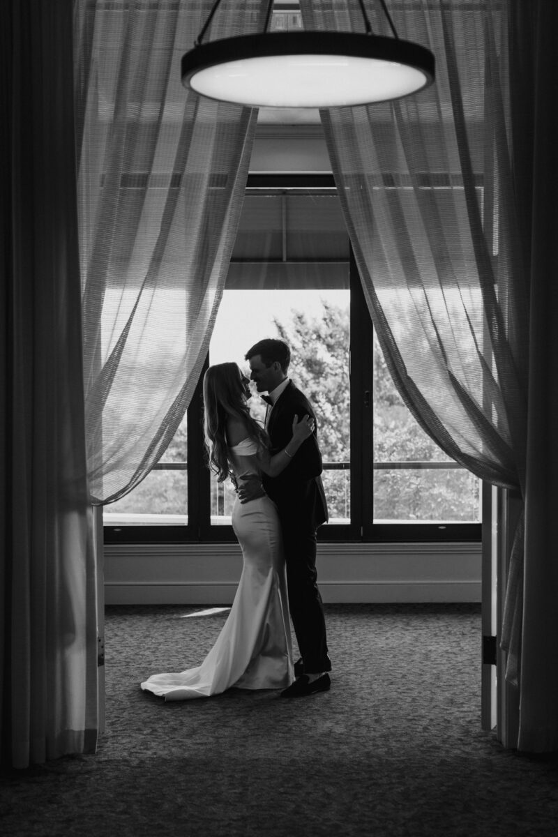 Black and white photo of bride and groom first look