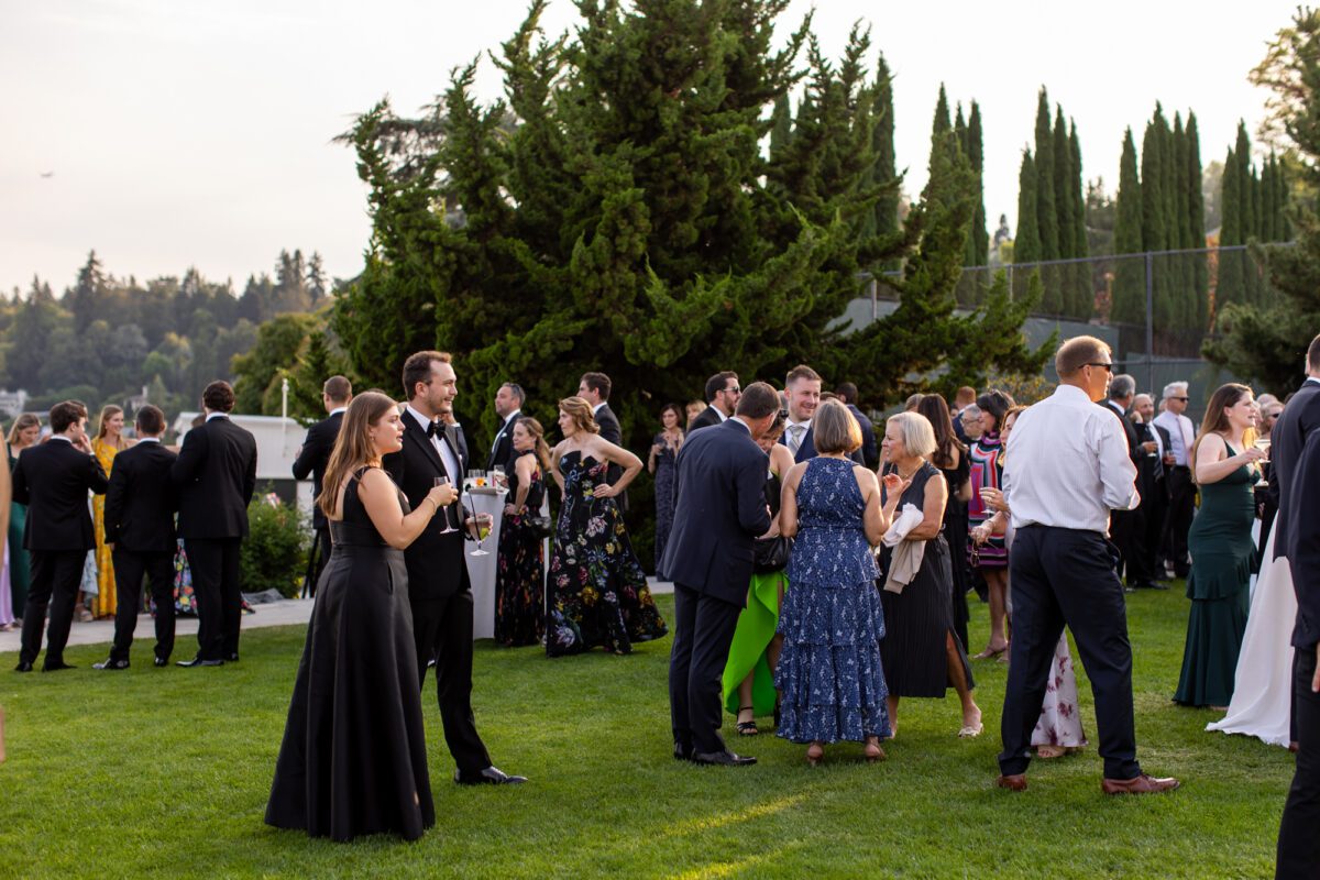 Guests mingling on lawn of outdoor Seattle wedding reception