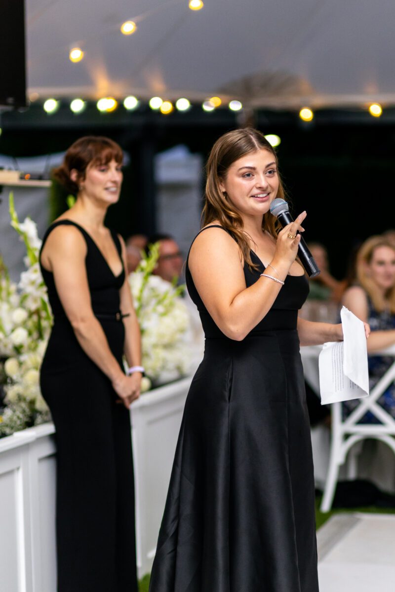 Maid of honor giving speech during Seattle tent outdoor summer wedding