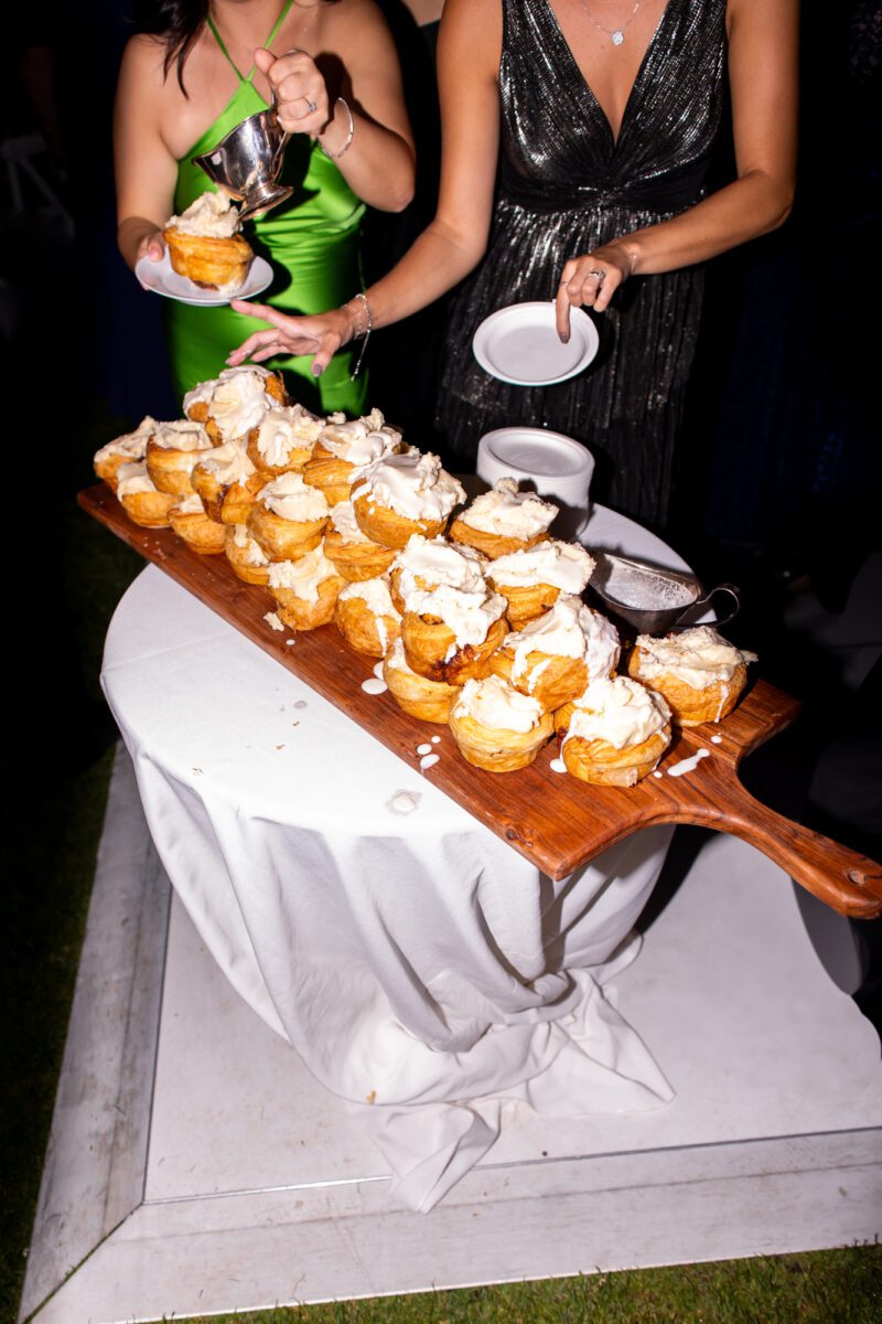 Guests grabbing cinnamon rolls instead of wedding cake