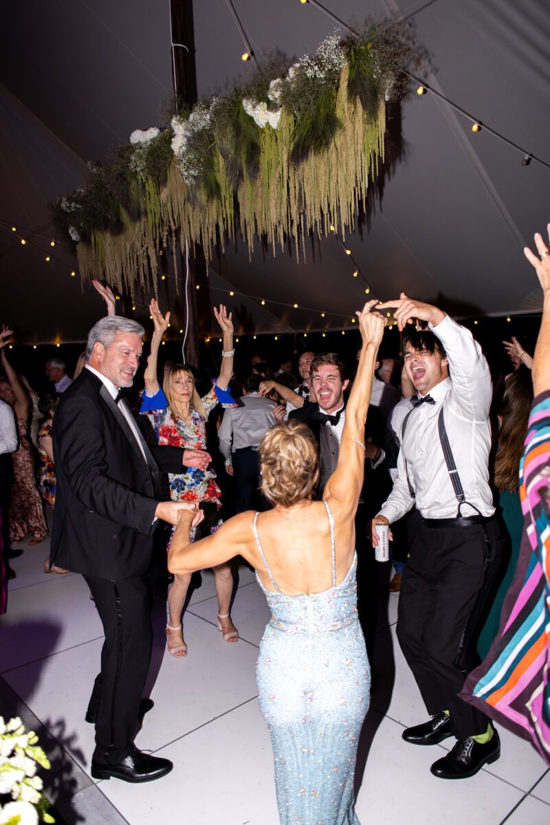 Guests dancing during outdoor tent wedding at the Seattle Tennis Club