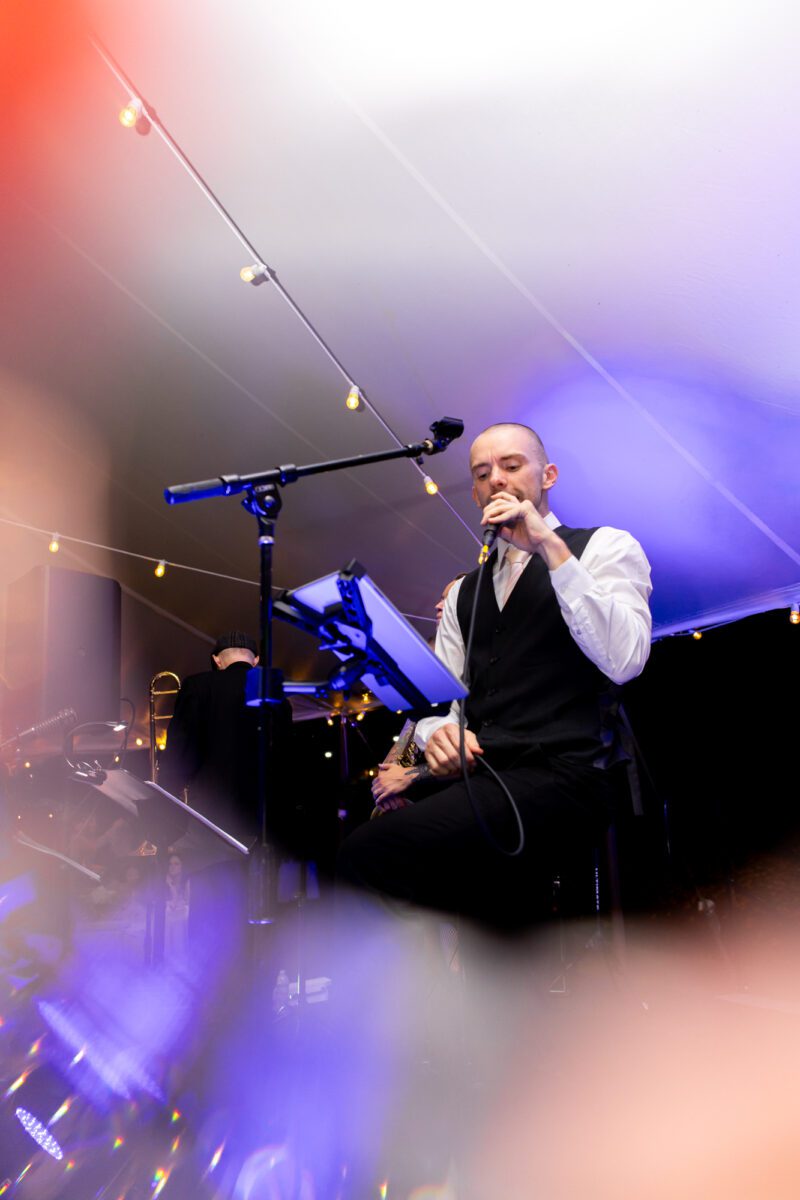 Band singer during tent wedding outdoors in Seattle