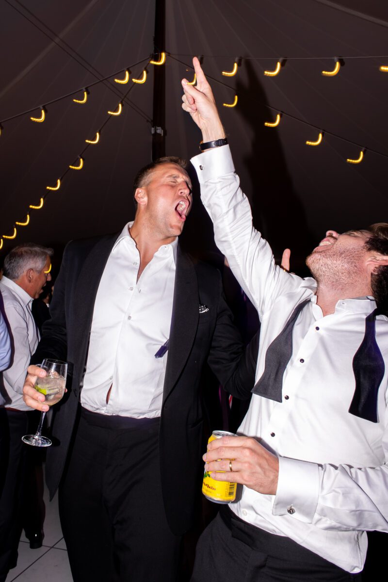 Guests dancing during outdoor tent wedding at the Seattle Tennis Club