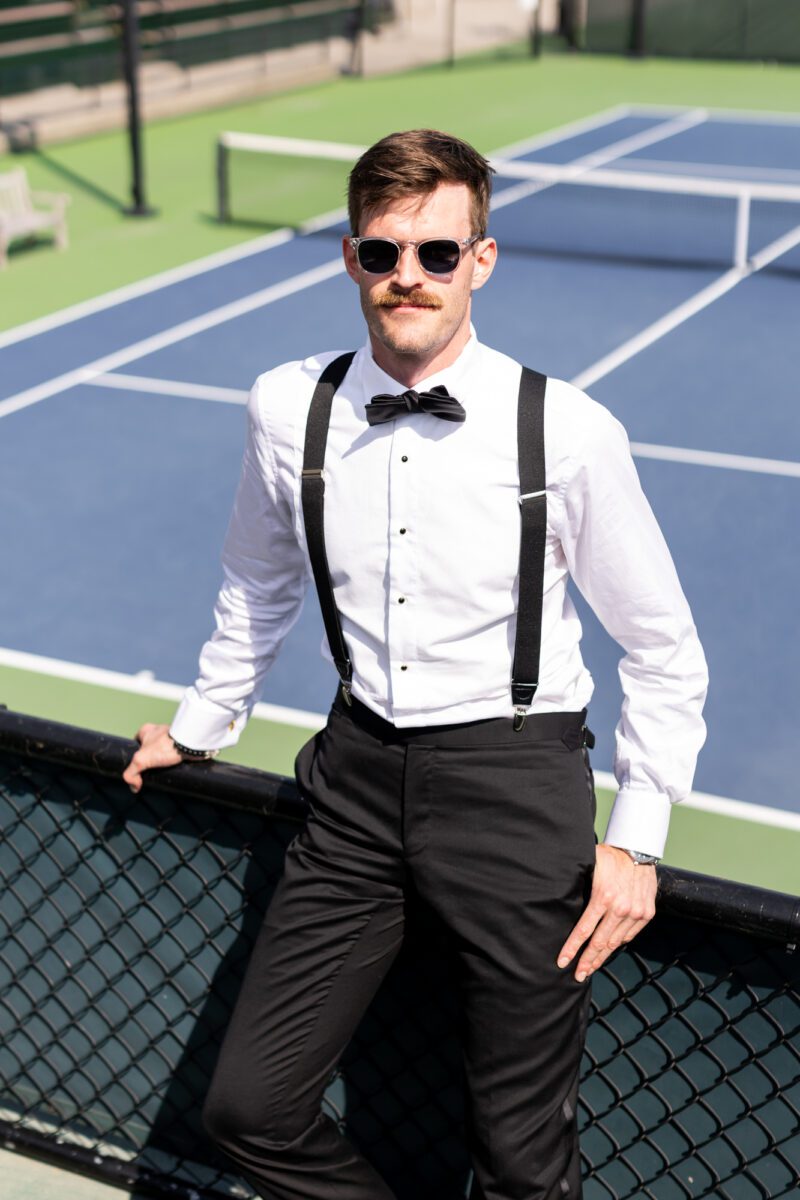 Groom portrait on tennis court at Seattle Tennis Club wedding
