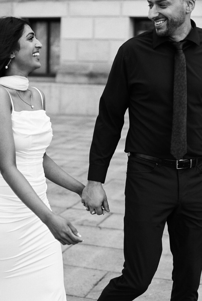 black and white film photos of bride and groom walking together outside of the washington state capitol