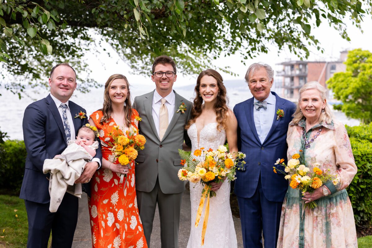 Family photos on the lake ahead of Seattle wedding, yellow and orange, colorful flowers, colorful mother dresses