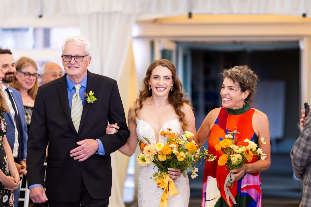 bride, walking down the aisle with her parents in Seattle tent, wedding ceremony
