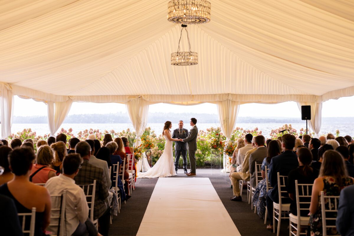 Bride and groom during outdoor tent, wedding ceremony at the Woodmark hotel, and still spa on Lake Washington