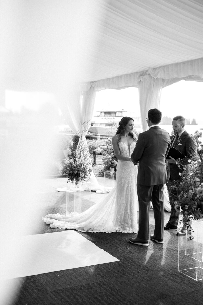 Bride and groom during outdoor tent, wedding ceremony at the Woodmark hotel, and still spa on Lake Washington