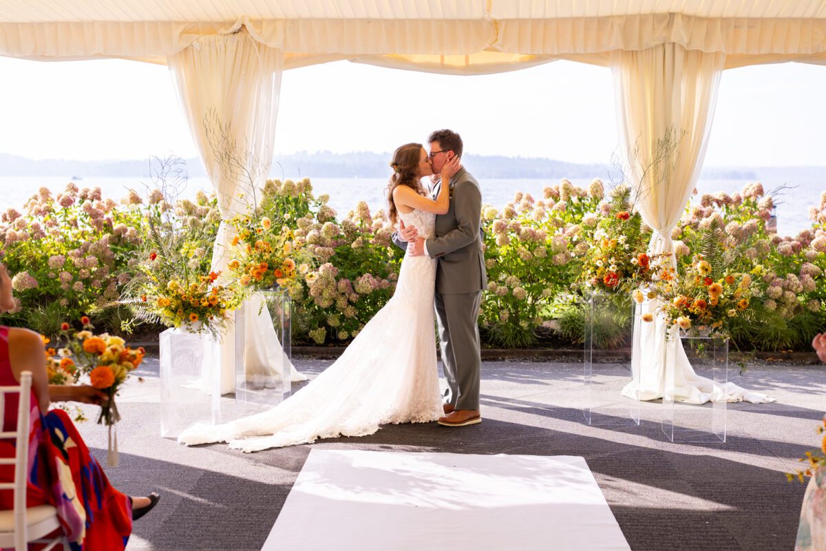 Bride and groom during outdoor tent, wedding ceremony at the Woodmark hotel, and still spa on Lake Washington