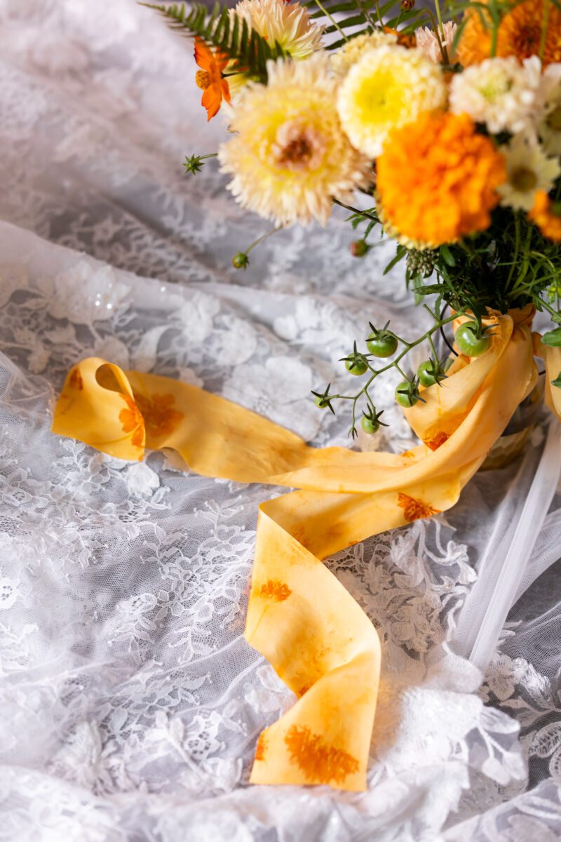 Close-up photo of hand, dyed silk ribbon on brides flowers for wedding