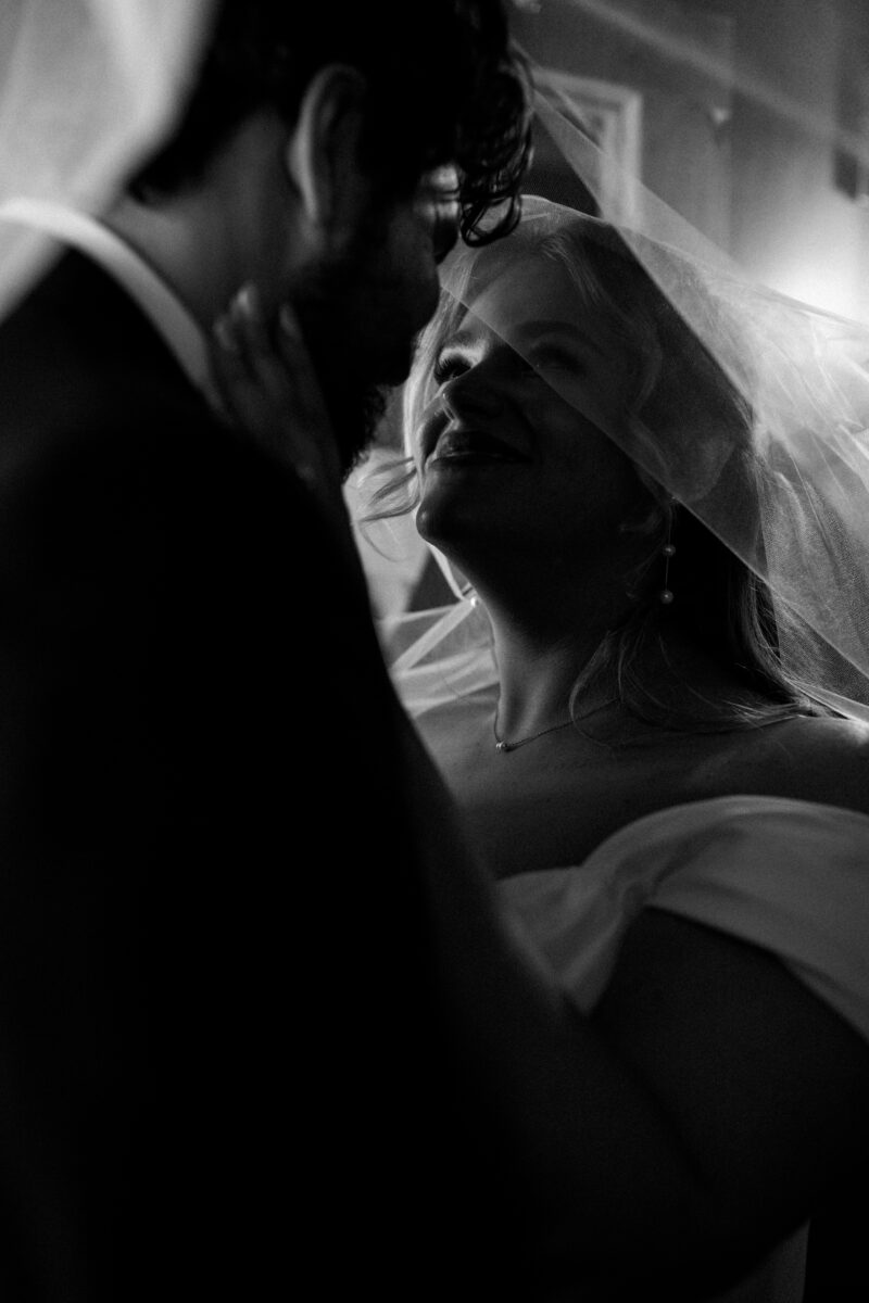 Bride and groom portraits upstairs in Bellingham for their Chuckanut Bay Distillery wedding, under veil photo