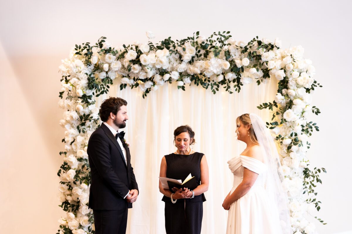 bride and groom during ceremony at indoor wedding ceremony in Bellingham, Chuckanut Bay Distillery wedding