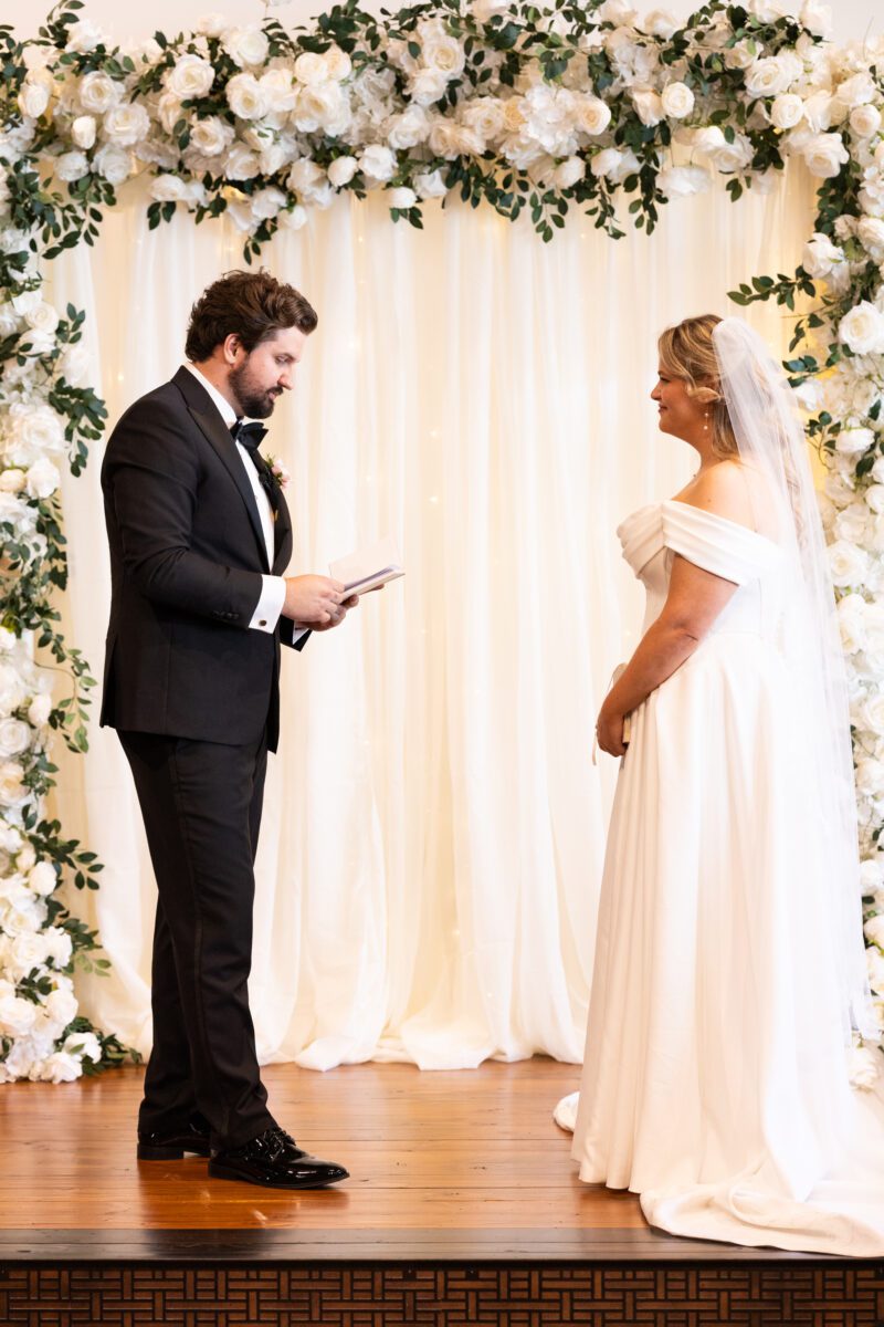 bride and groom during ceremony at indoor wedding ceremony in Bellingham, Chuckanut Bay Distillery wedding