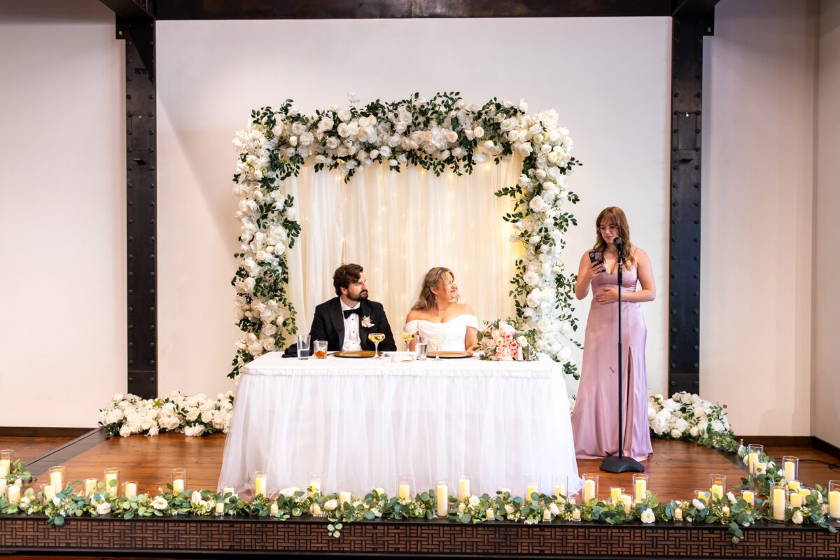 bride and groom during speeches during chuckanut bay distillery wedding