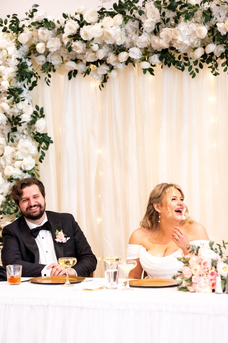 bride and groom during speeches during chuckanut bay distillery wedding