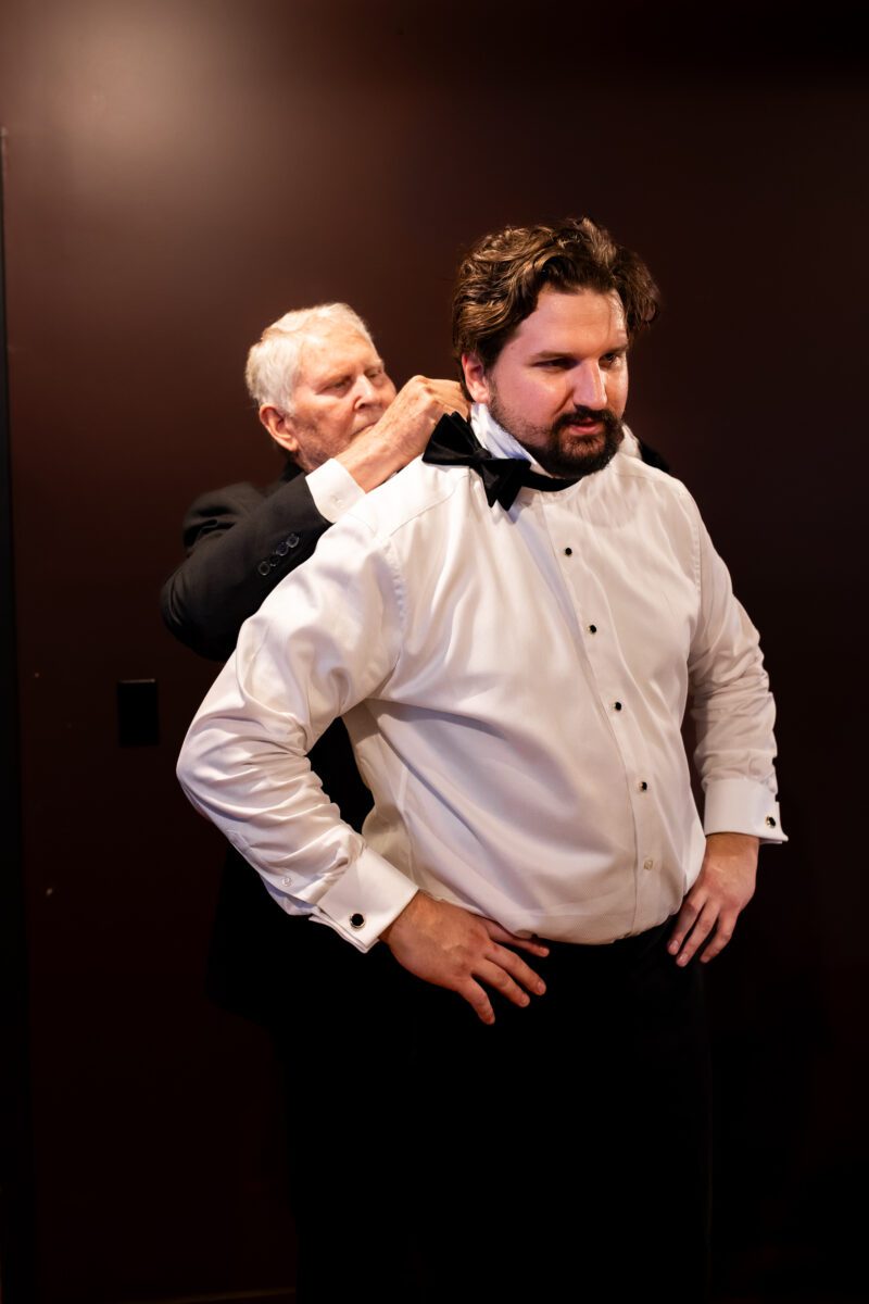 Groom's dad helping groom put on bow tie during getting ready in Bellingham