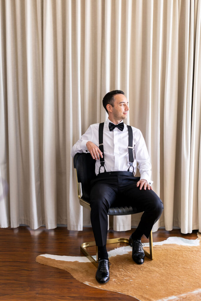 groom sits in chair