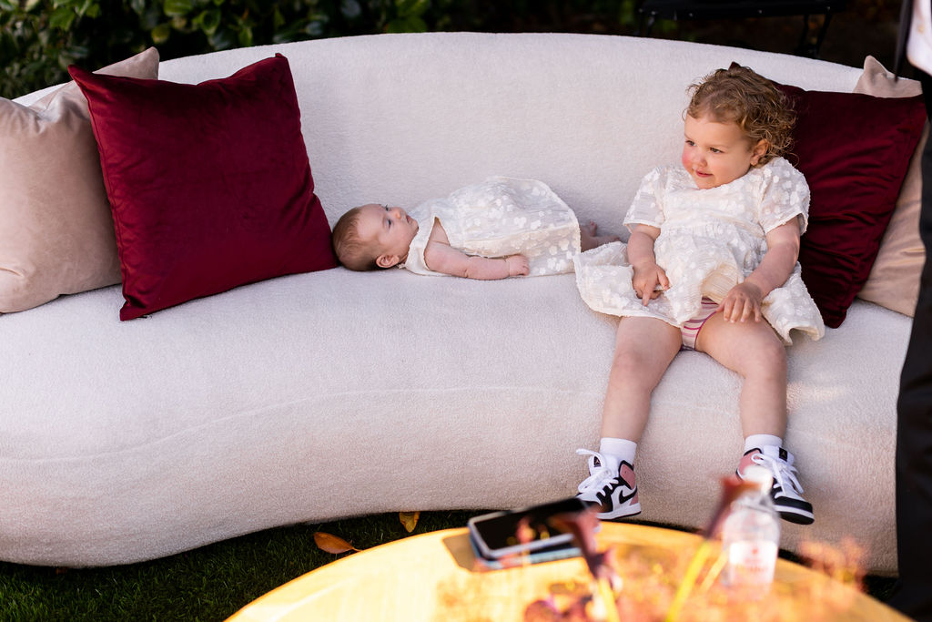 two little girls sitting on couch