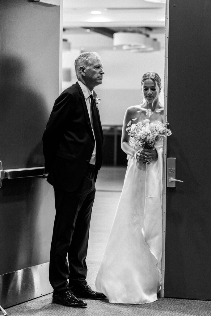 Black and white image of dad and bride waiting to walk down the aisle at Alderbrook Resort