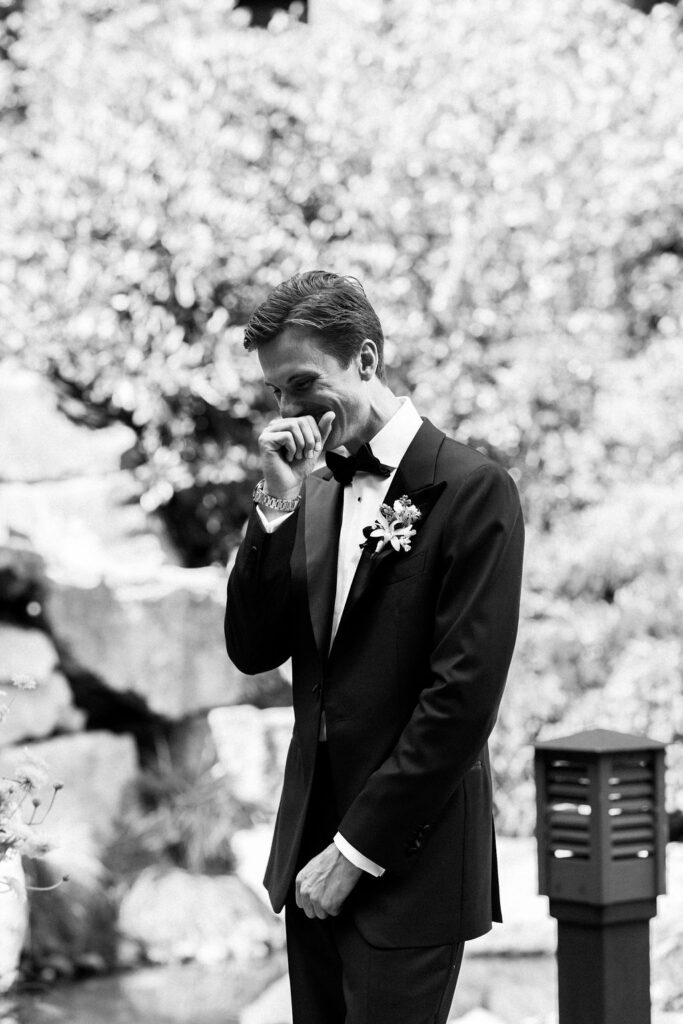 groom smiles at bride